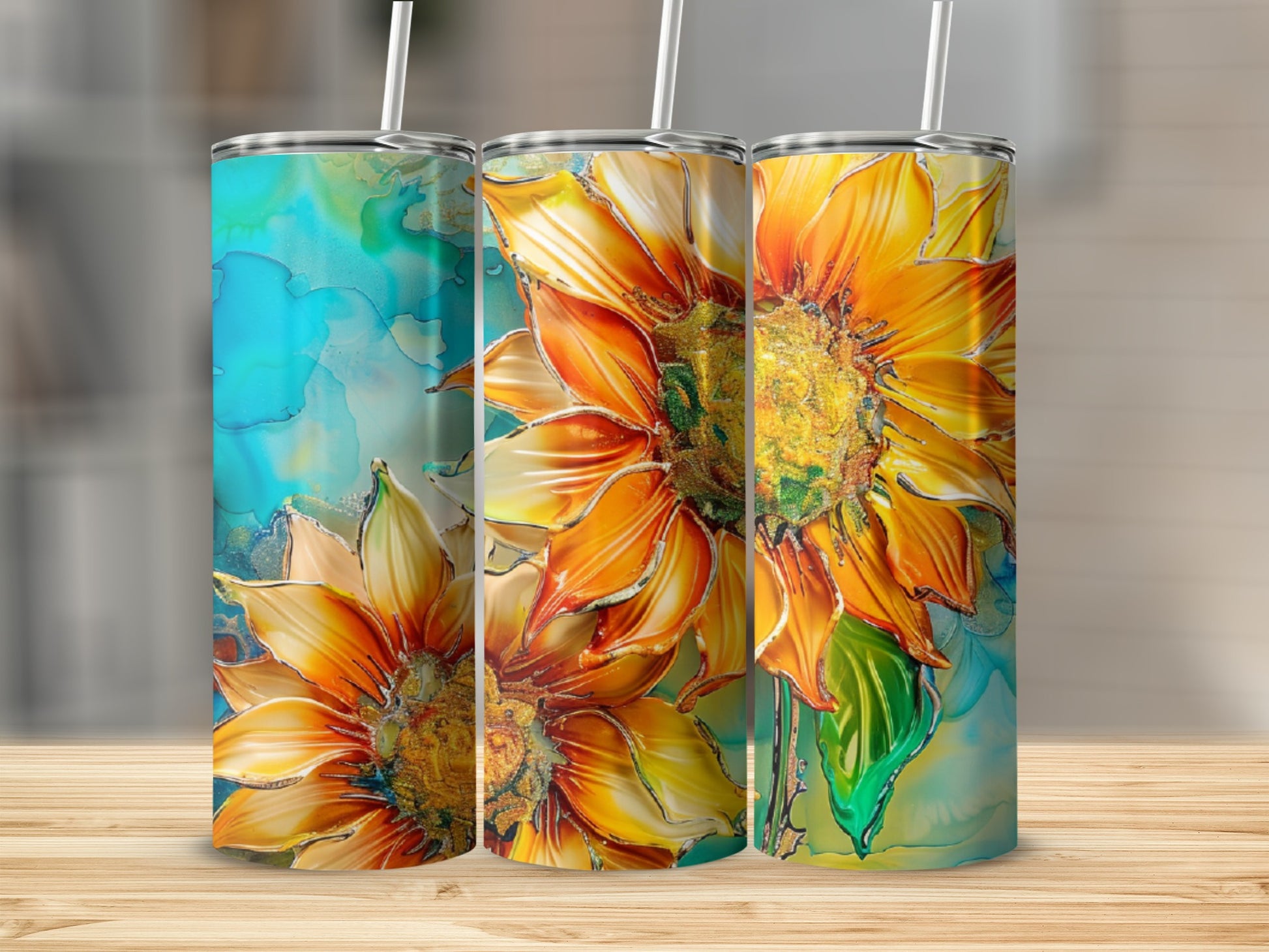 Three tumblers with vibrant sunflower designs on a wooden surface.