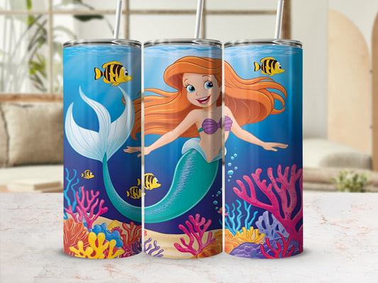 Ariel the mermaid swims with fish and coral reefs.