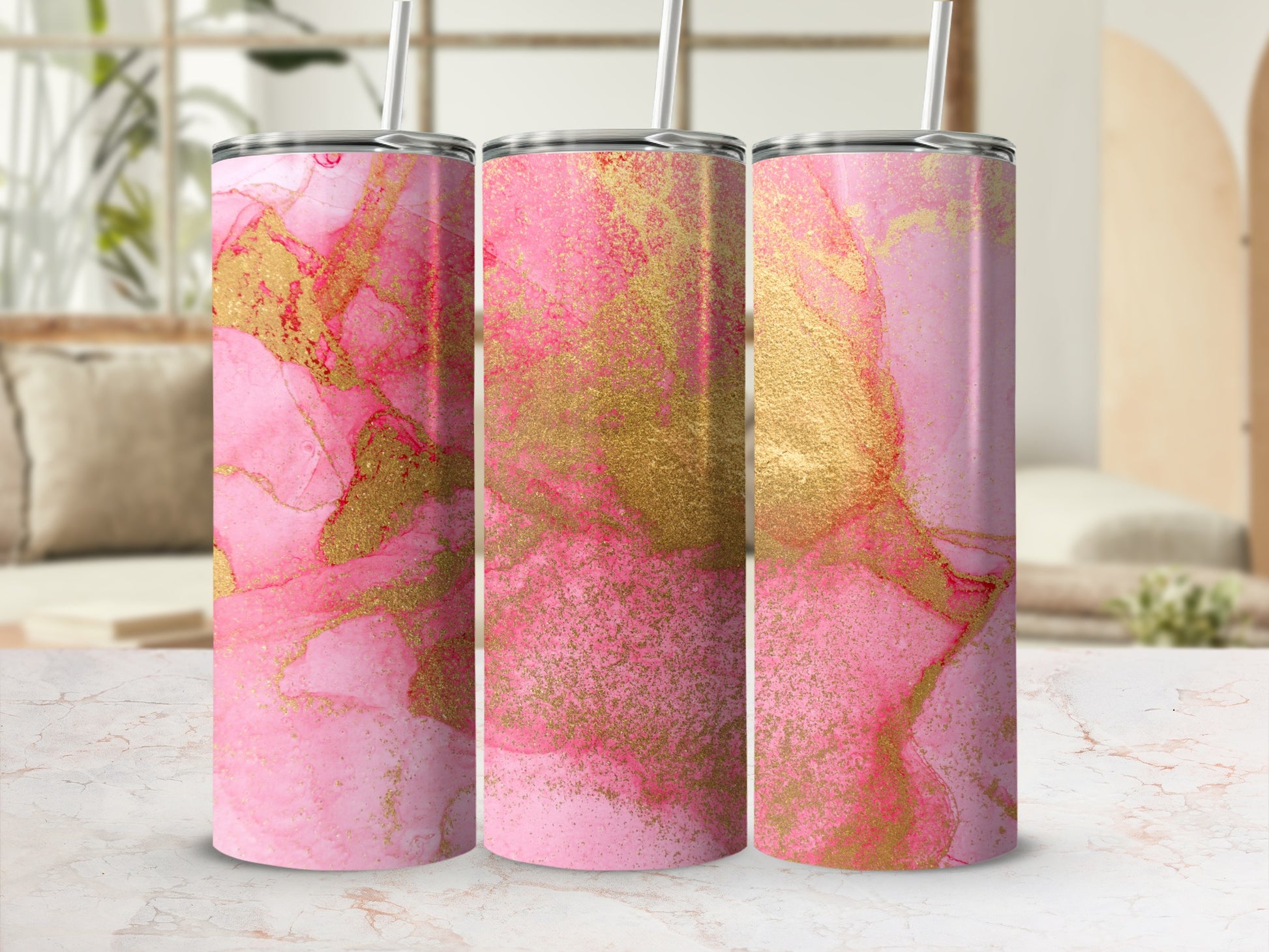 Three pink and gold abstract alcohol ink tumblers with straws.
