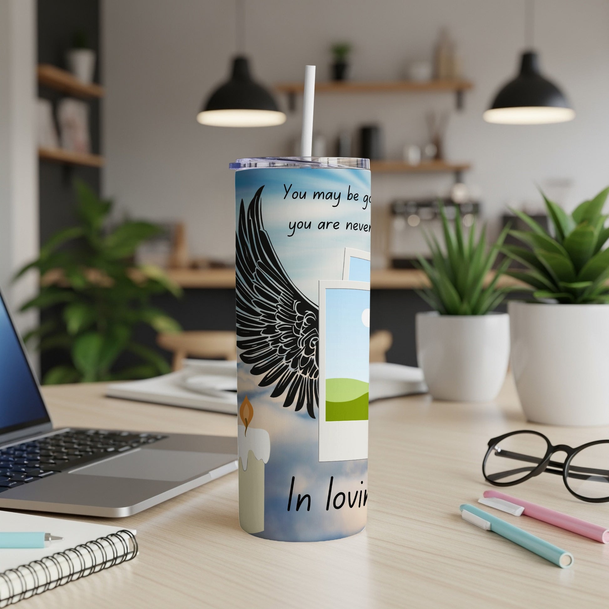 Tall tumbler with angel wings, candle, photos, and text "You may be gone, you are never forgotten. In loving memory."