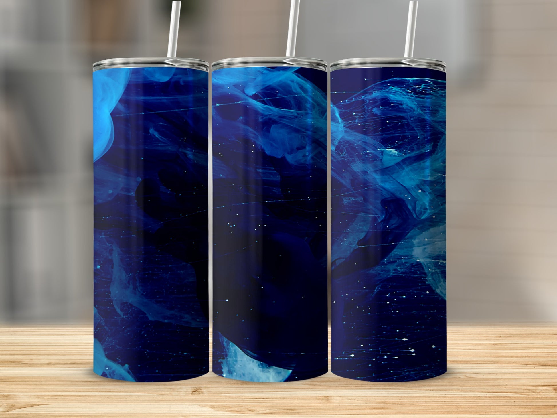 Three tumblers with swirling blue and white abstract ink designs.
