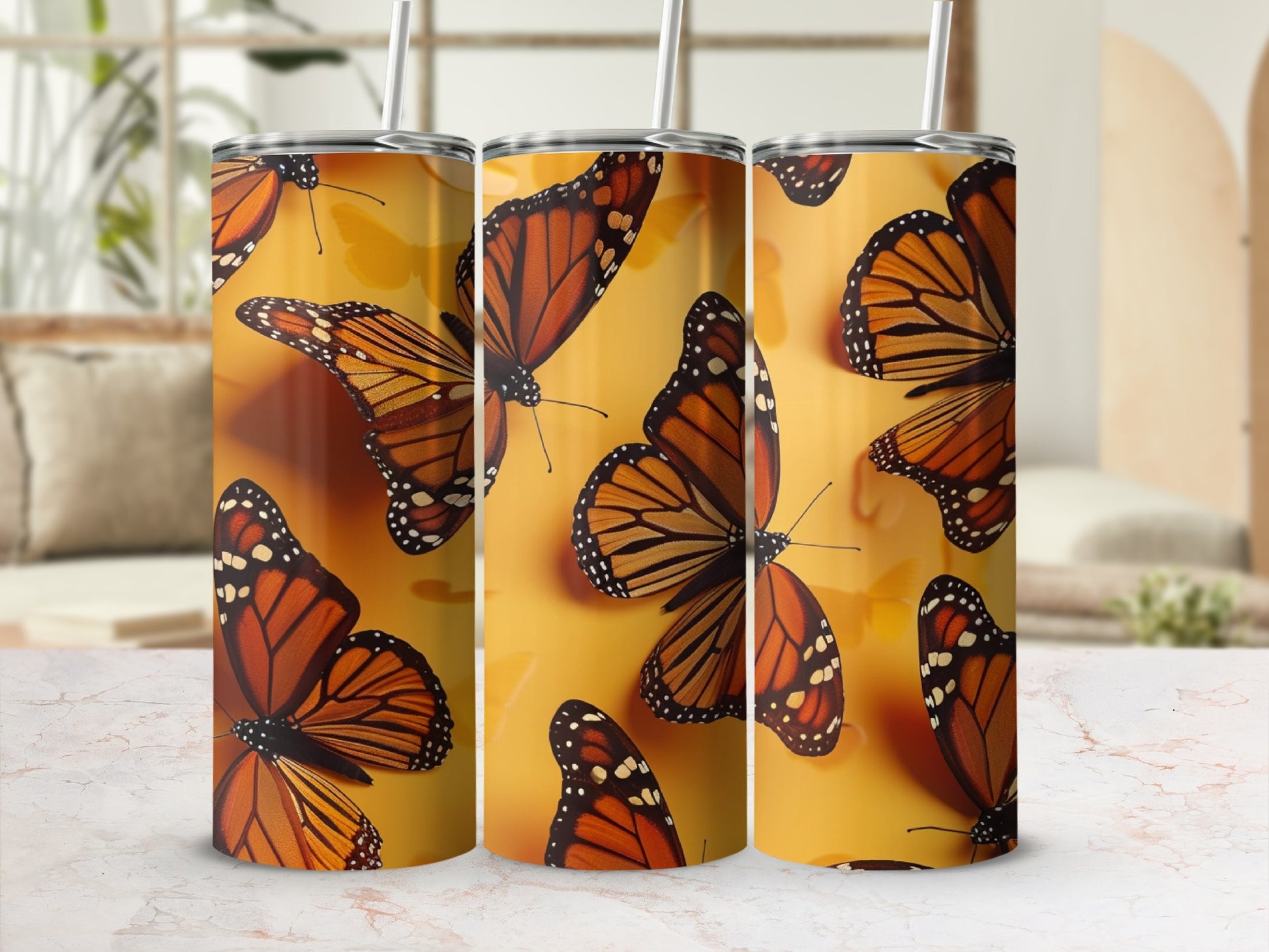 Three tumblers with monarch butterfly pattern on a yellow background.