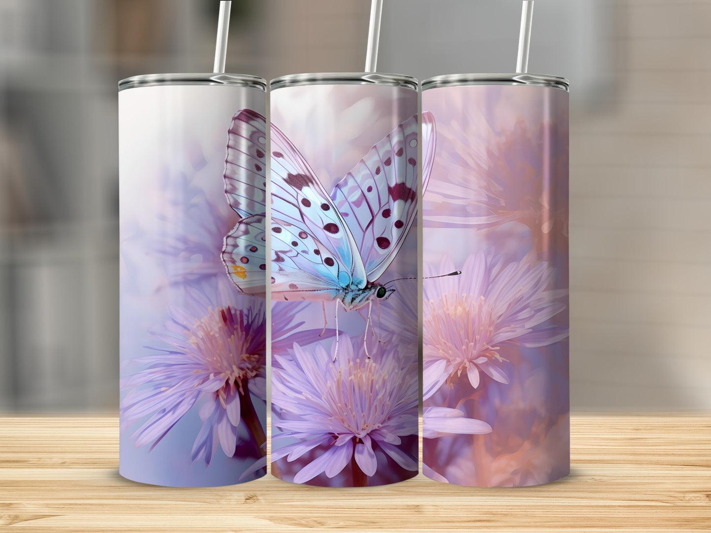 Three tumblers with a light blue butterfly and purple flowers design.