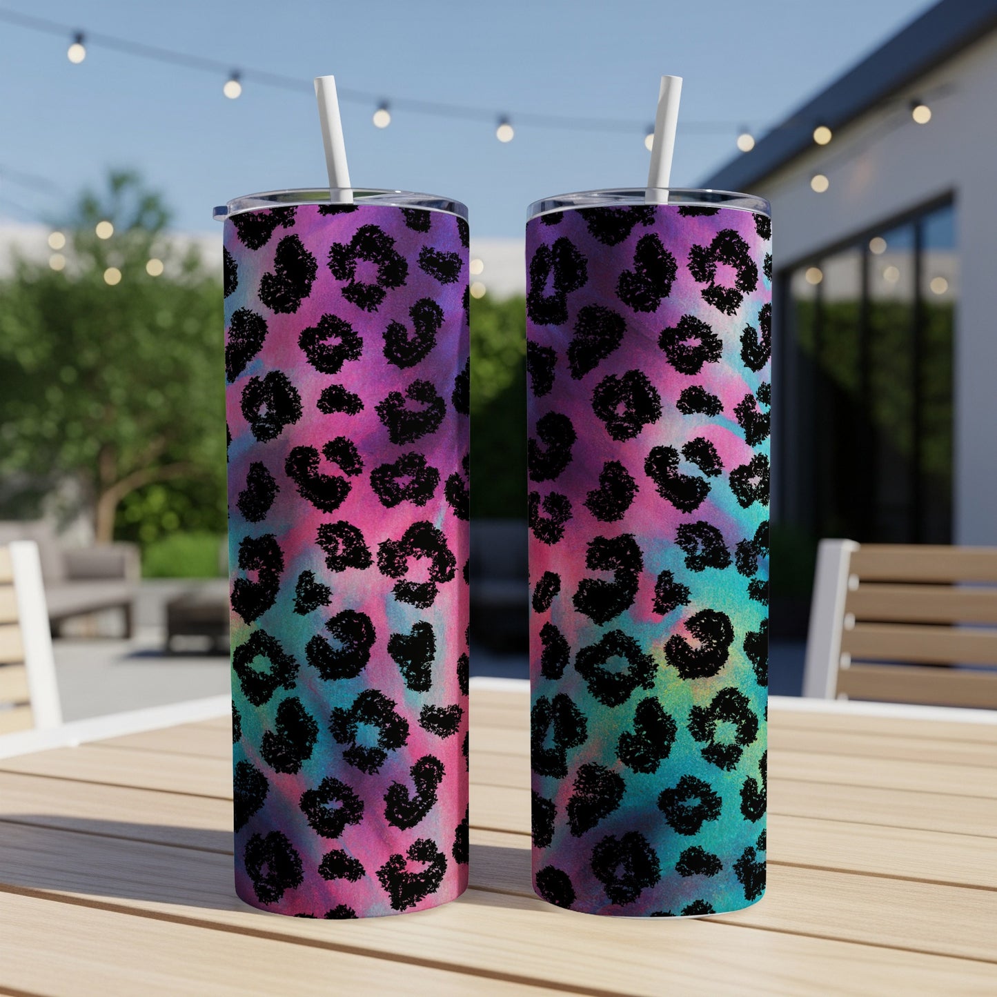 Two tumblers with black leopard print on a watercolor tie-dye background.