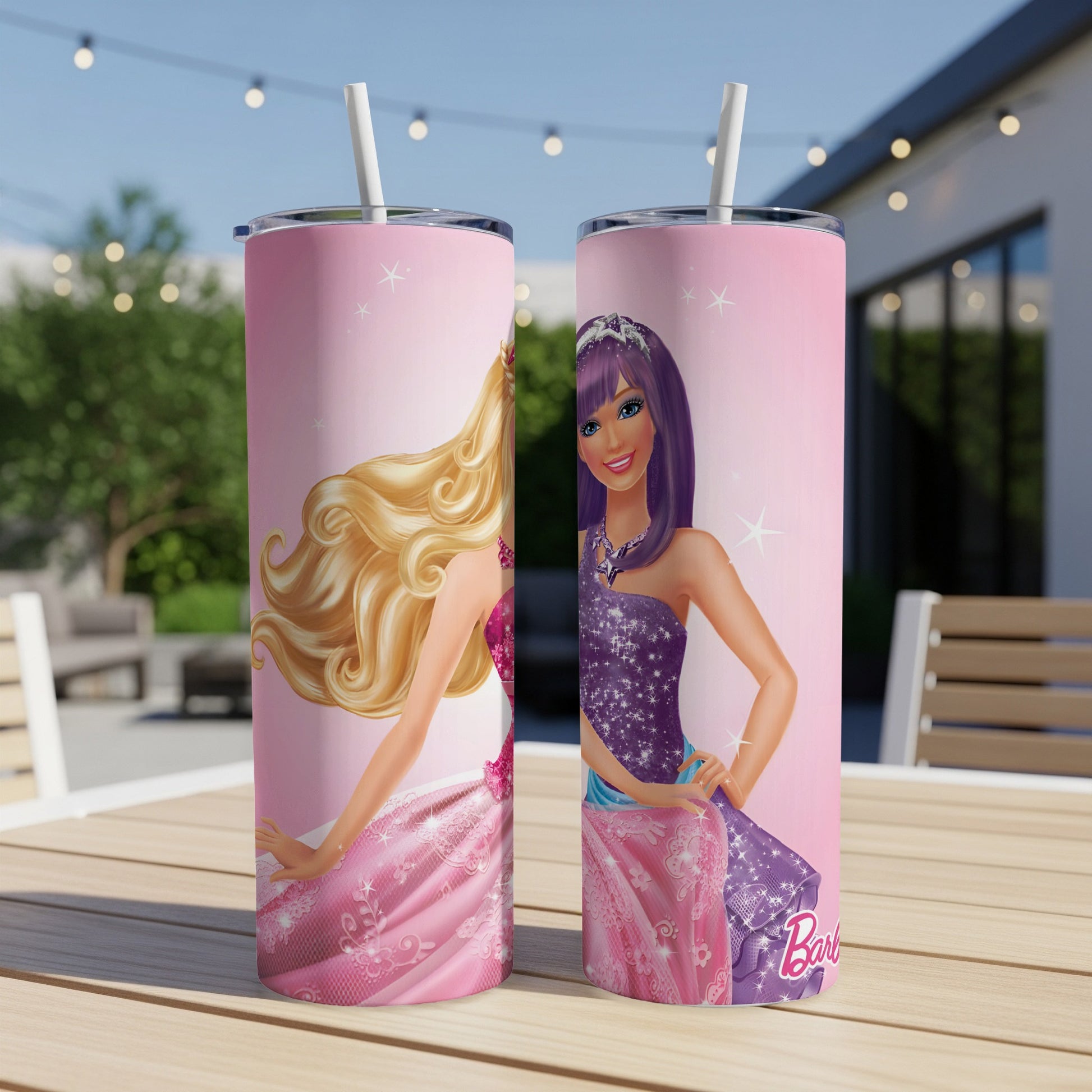 Two Barbie tumblers with pink and purple princess designs on a wooden table.