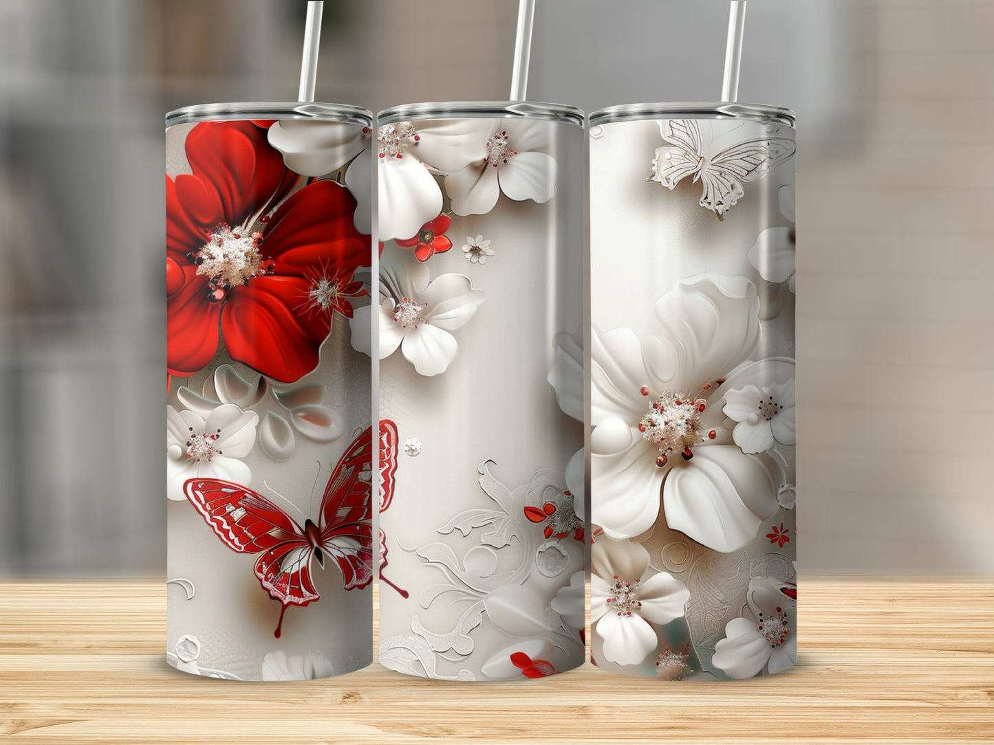 Three tumblers with red and white flowers and butterflies.