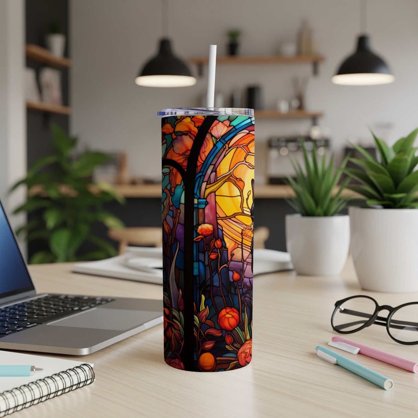 Tumbler with stained glass design featuring flowers and a cathedral arch.