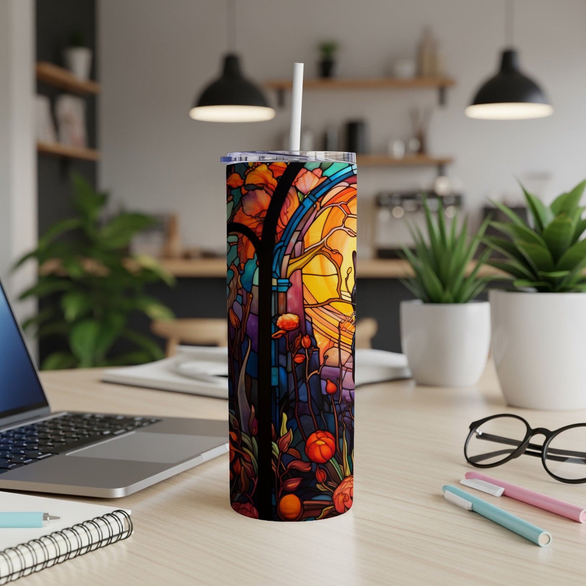 Tumbler with stained glass design featuring flowers and a cathedral arch.