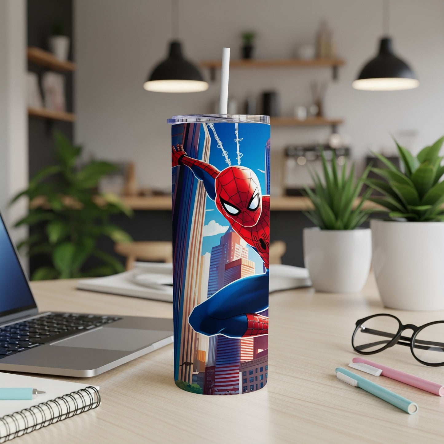 Spider-Man in action against a city skyline on a blue stainless steel tumbler.