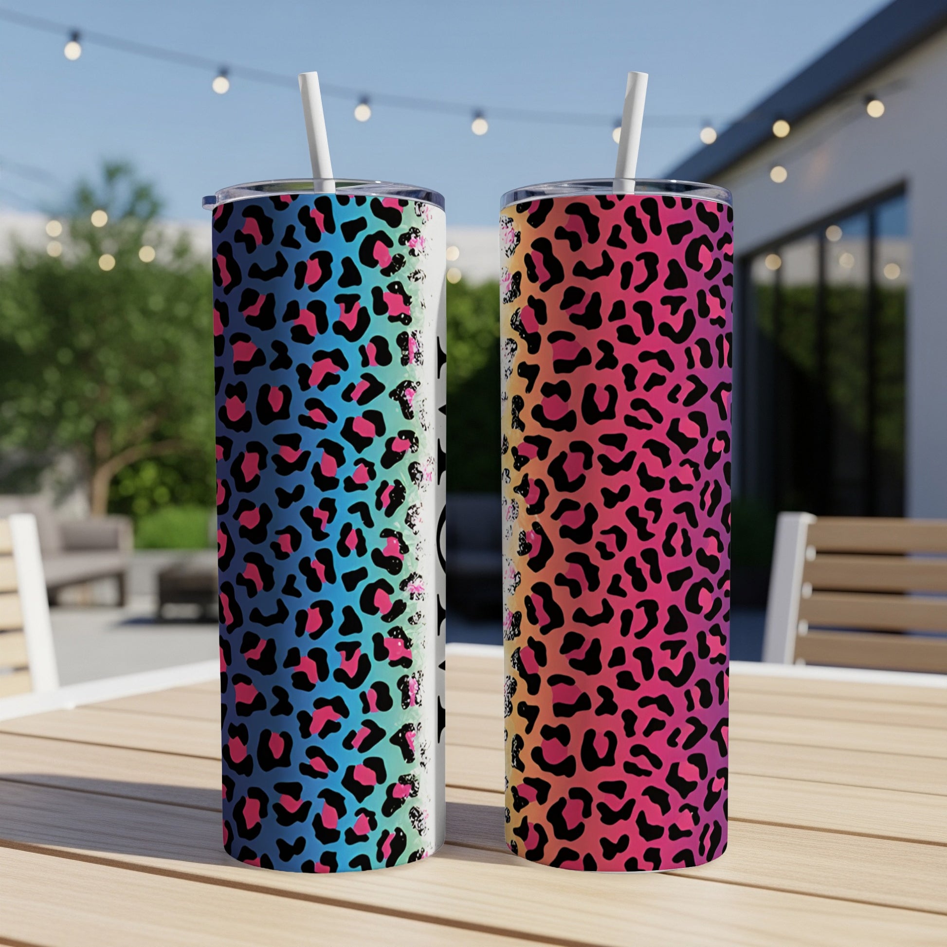 Two tall tumblers with colorful leopard print and black stars, set outdoors.