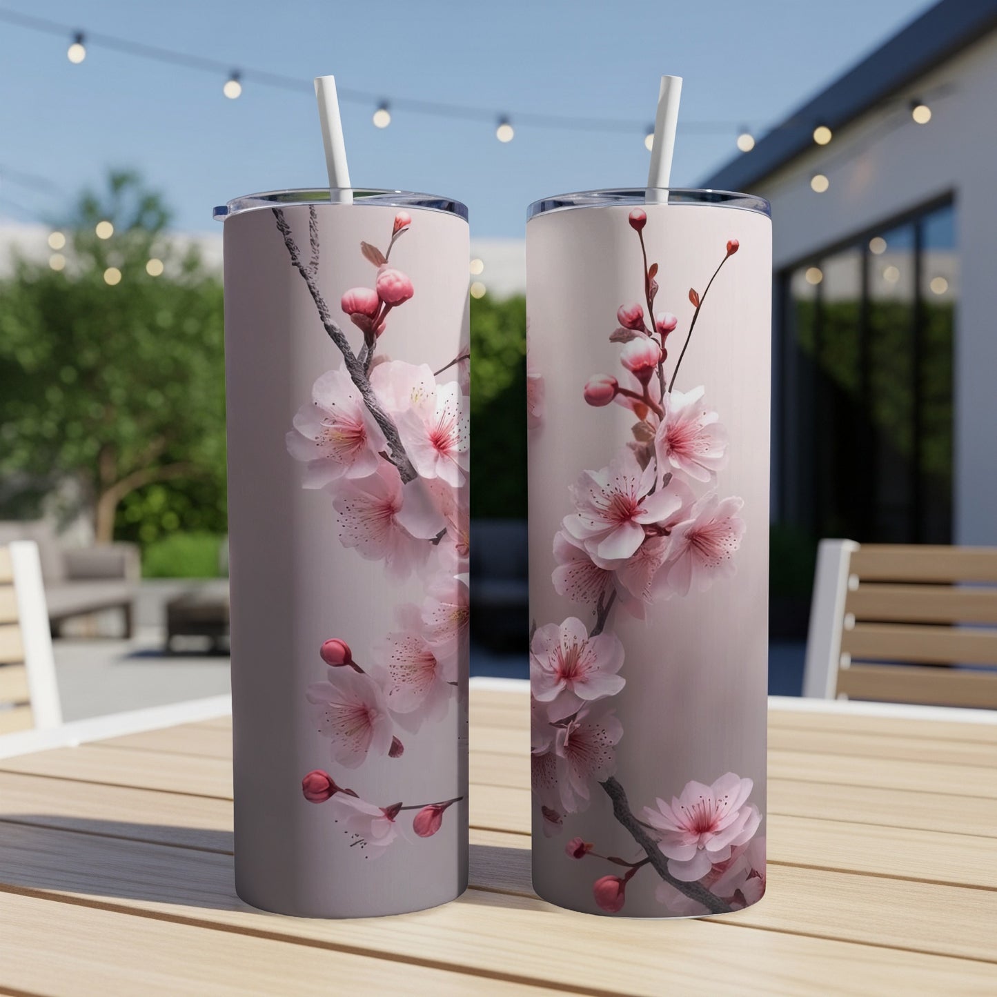 Two tall tumblers with delicate pink cherry blossoms on a muted background.