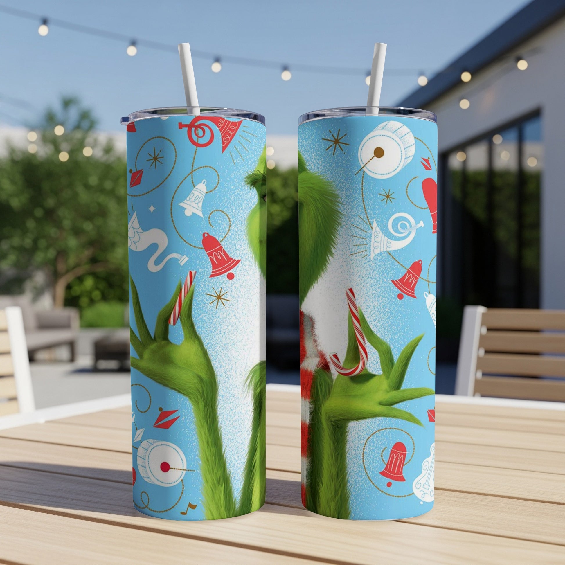 Two Grinch-themed tumblers with festive holiday icons and candy canes.