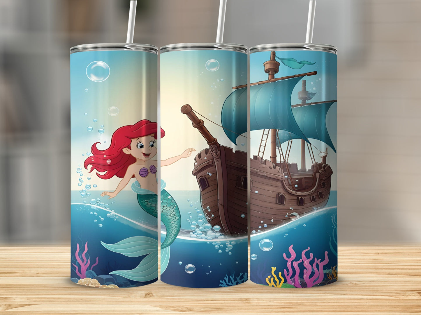 Ariel the mermaid swims beside a wooden ship with blue sails.