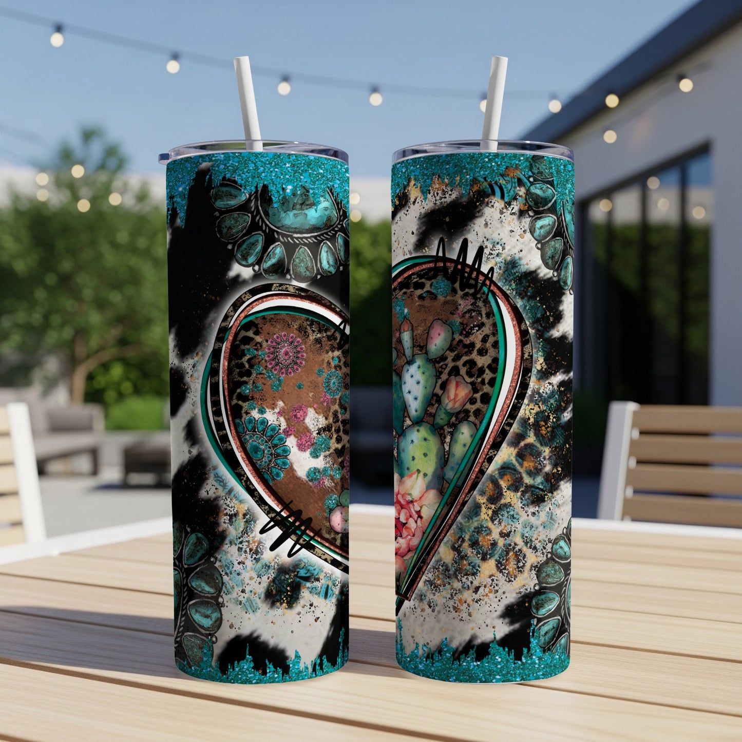 Two teal-lidded tumblers with heart-shaped western patterns and cacti.