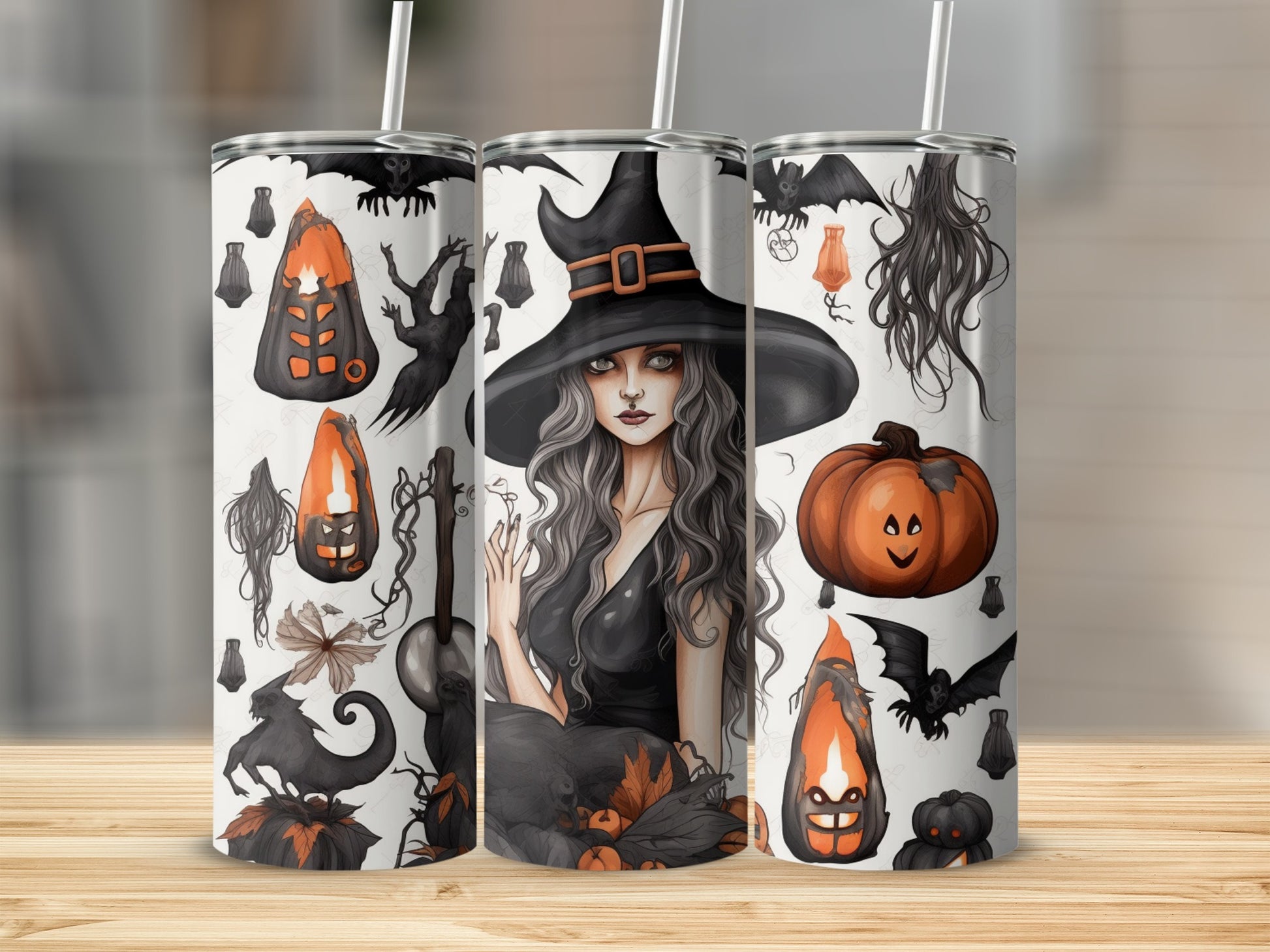 Three tumblers decorated with Halloween motifs including a witch and pumpkins.