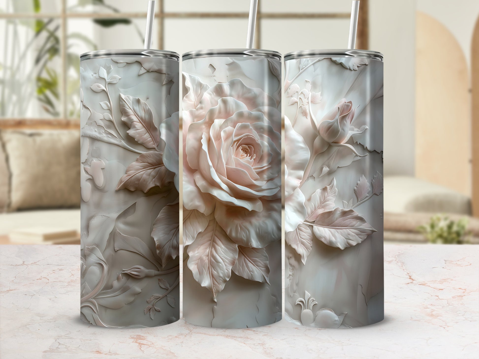 Three floral-embossed tumblers with lids and straws in a soft blush pink.