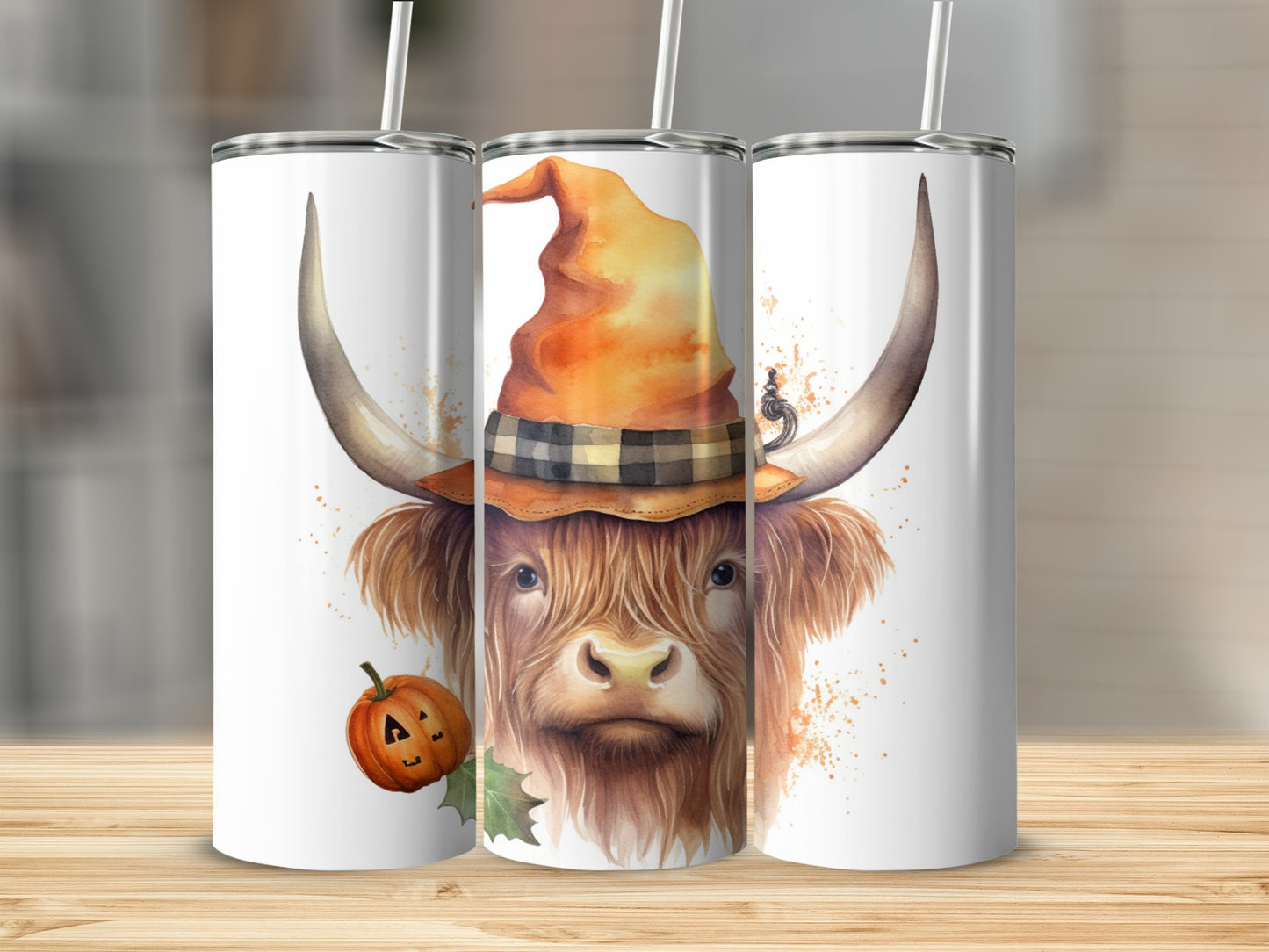 Highland cow in witch hat with pumpkin, on white tumblers.