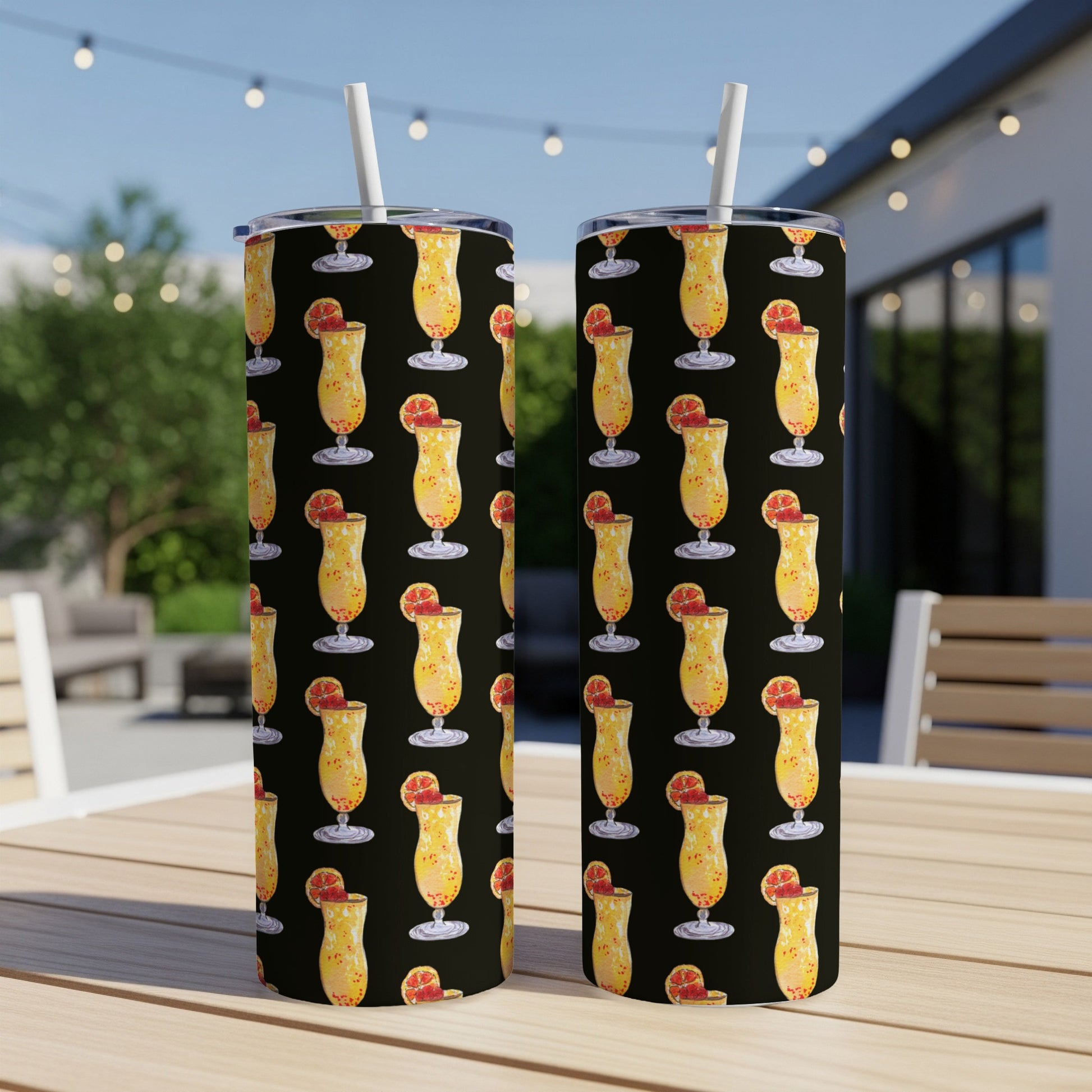 Two tumblers with a repeating pattern of a tropical cocktail.