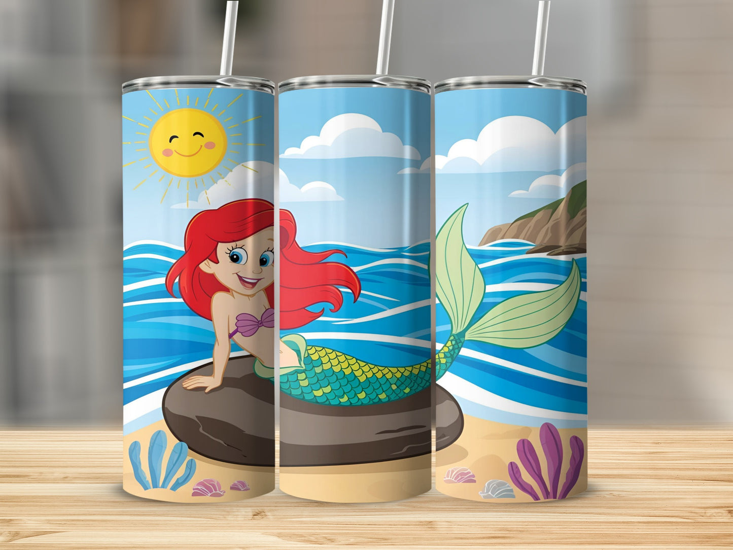 Mermaid on rock with ocean background, three tumblers displayed.
