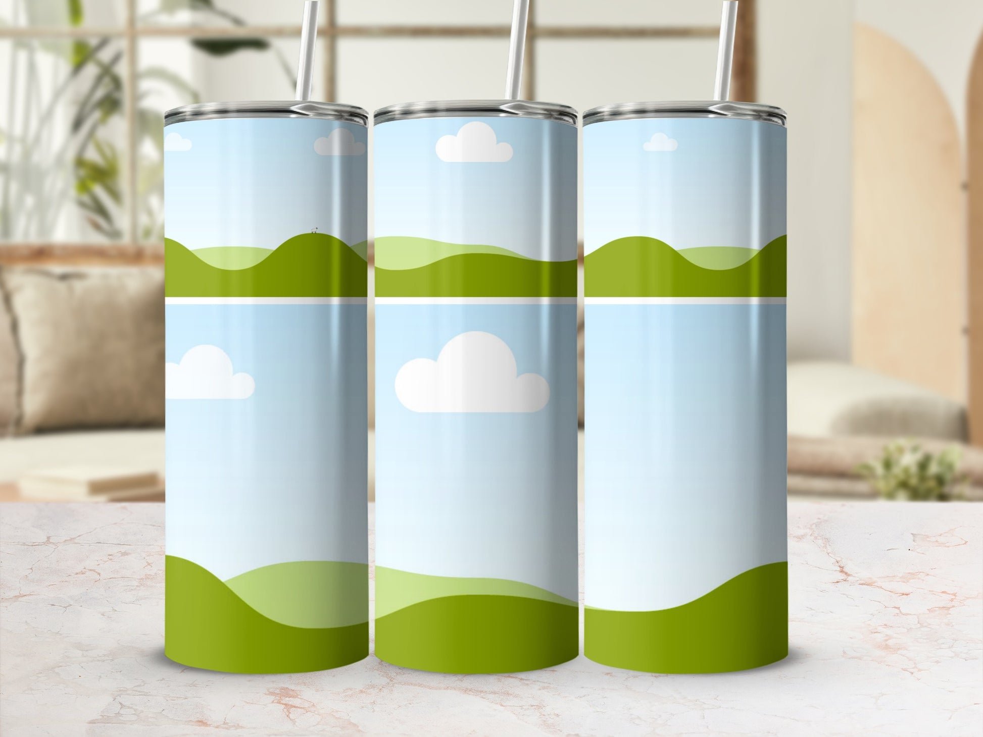Three tumblers with a split landscape design of rolling green hills and sky.