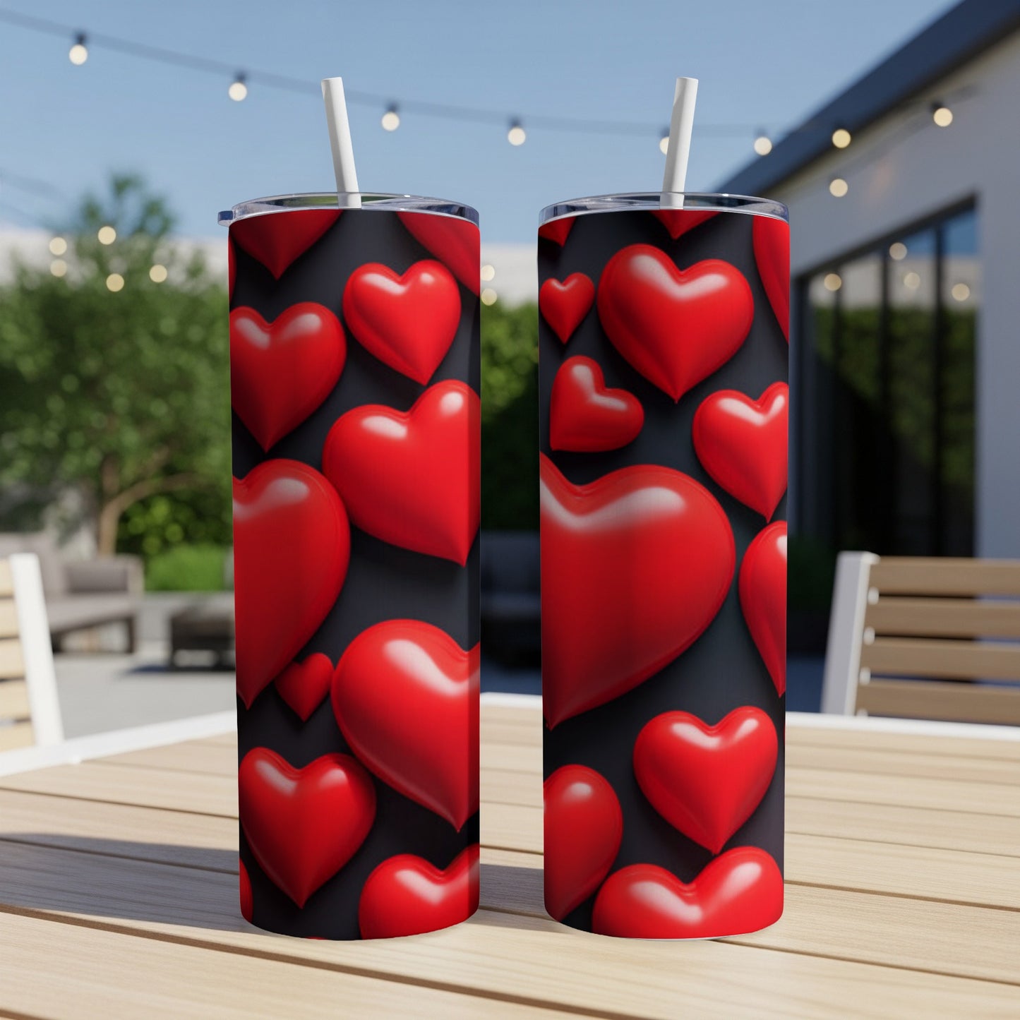 Two tall tumblers with red hearts pattern, set on a table.