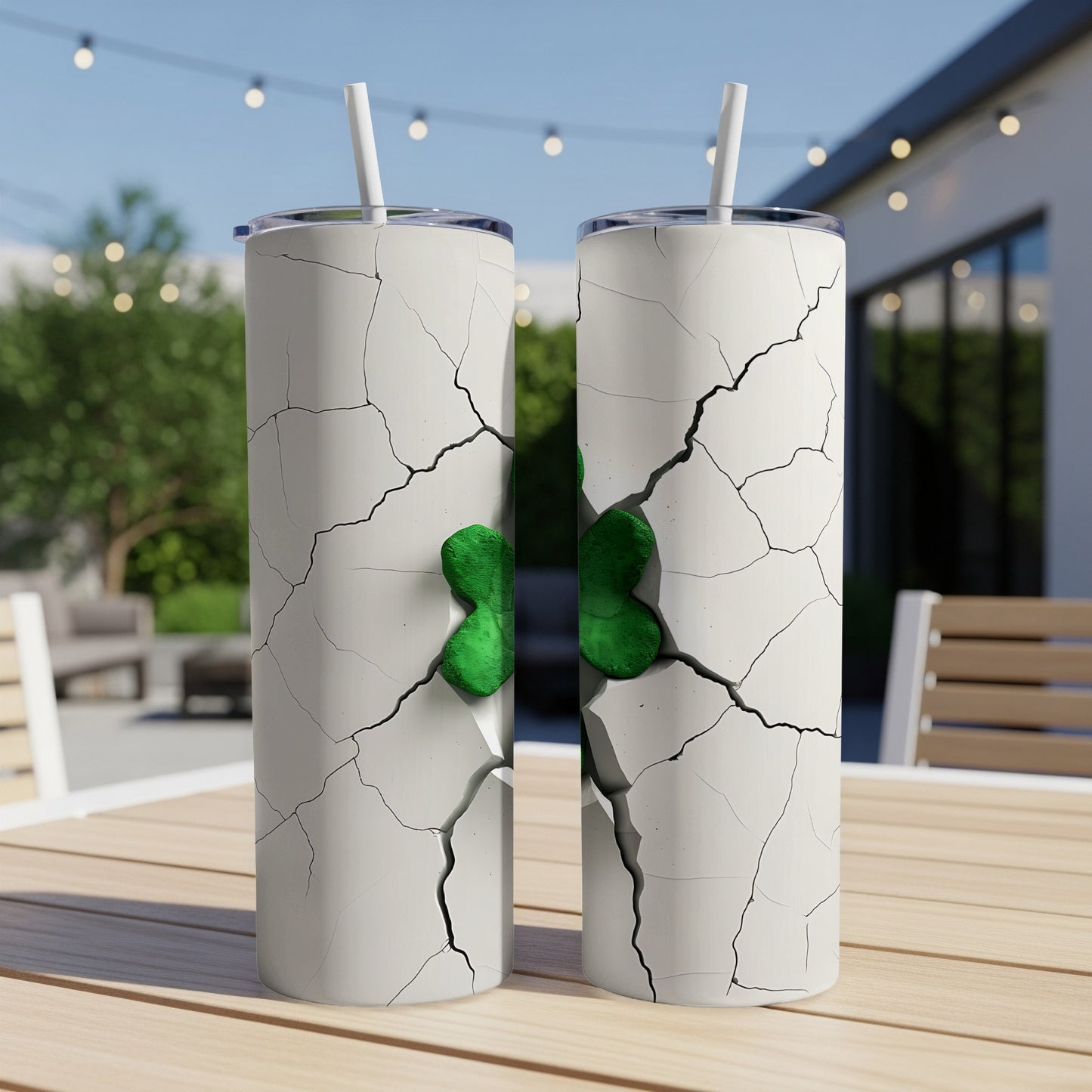 Two cracked white tumblers with green shamrocks protruding from the cracks.