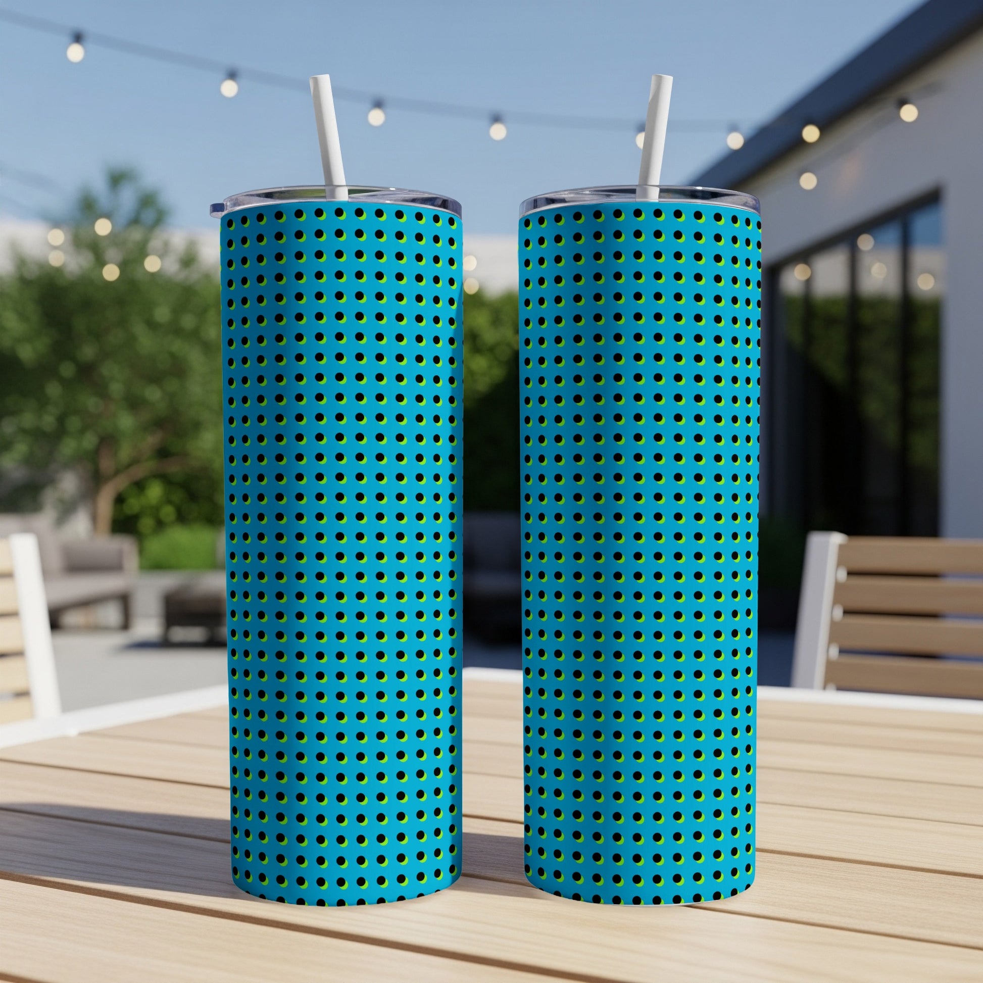 Two vivid blue tumblers with black and yellow polka dot pattern and white straws.