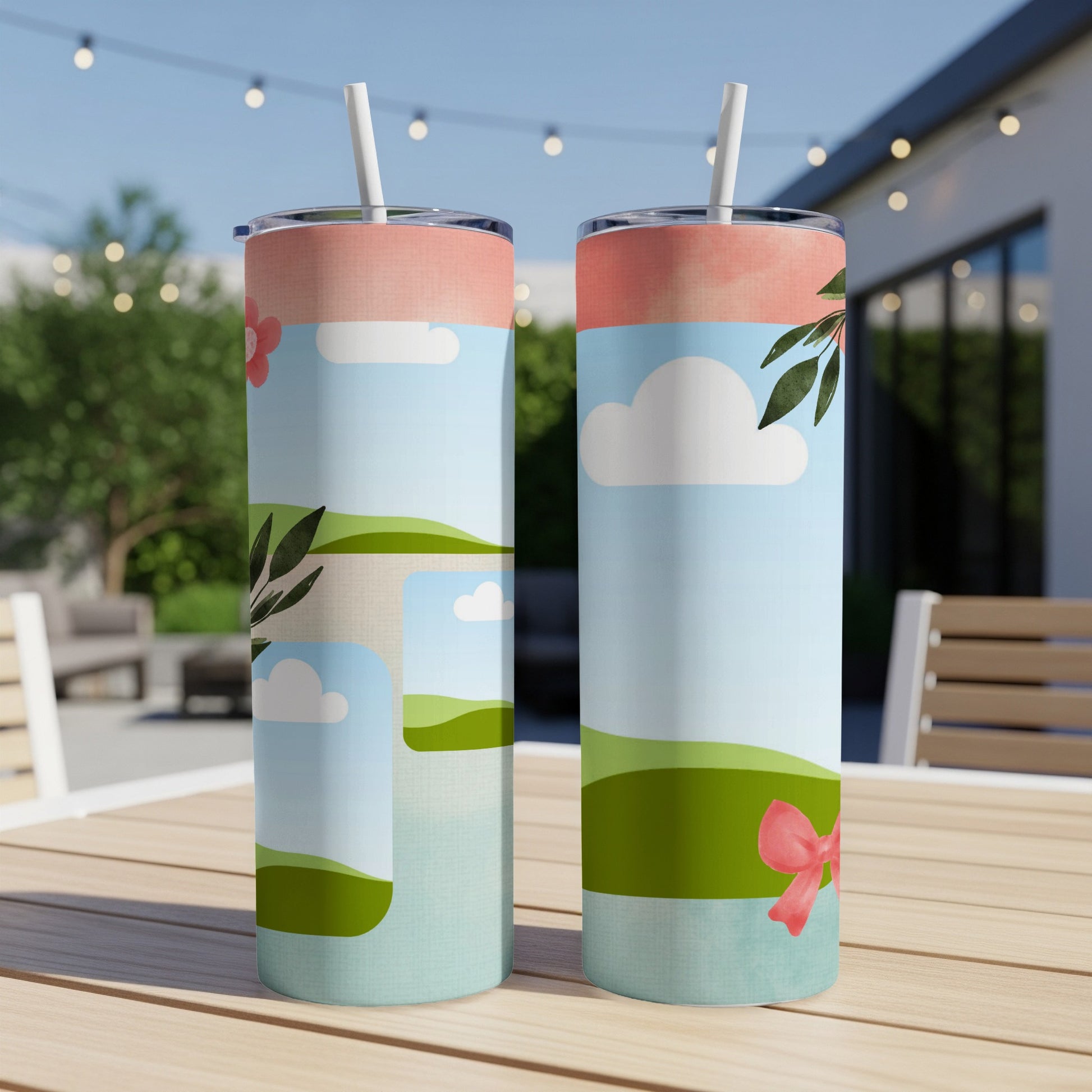 Two tumblers with a spring landscape design and a pink bow.