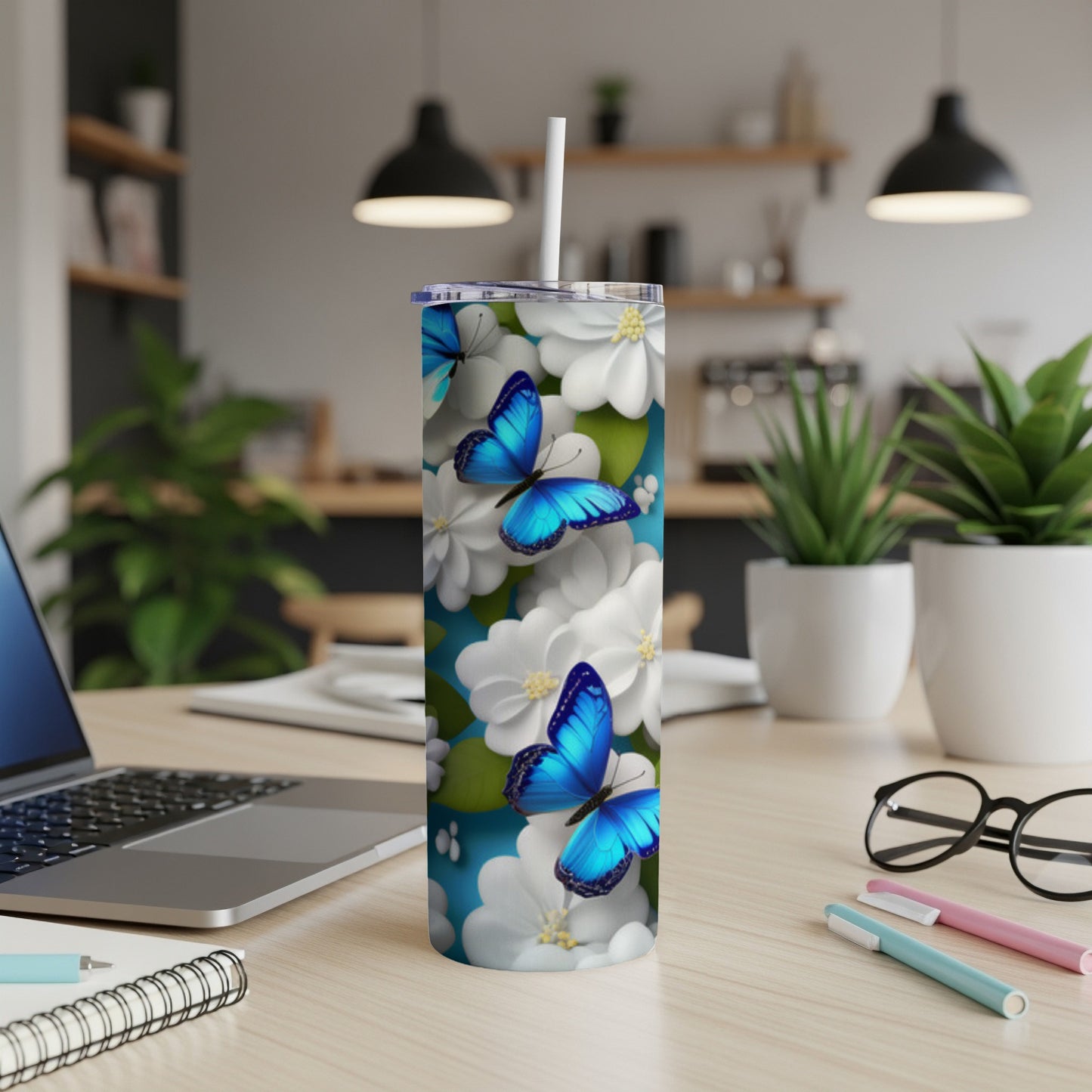Blue butterflies on a white floral pattern tumbler with a straw.