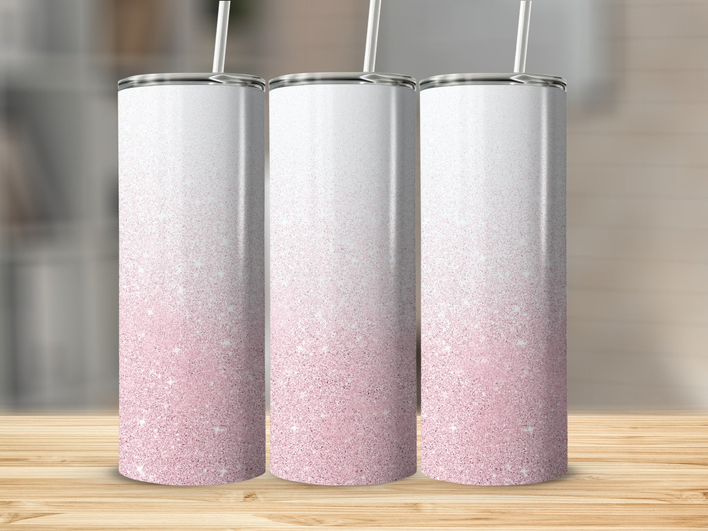 Three skinny tumblers with pink glitter gradient and white tops.