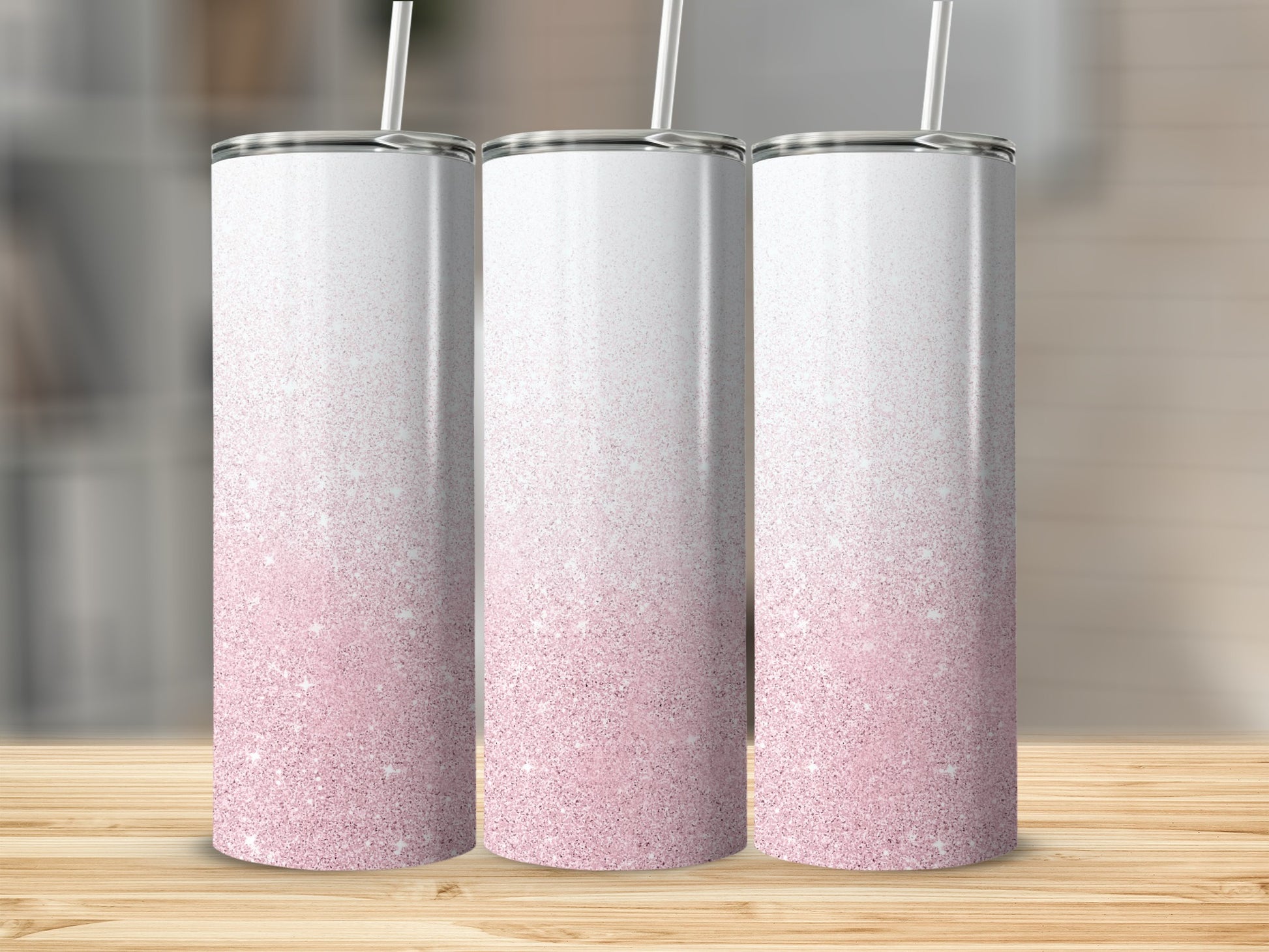 Three skinny tumblers with pink glitter gradient and white tops.