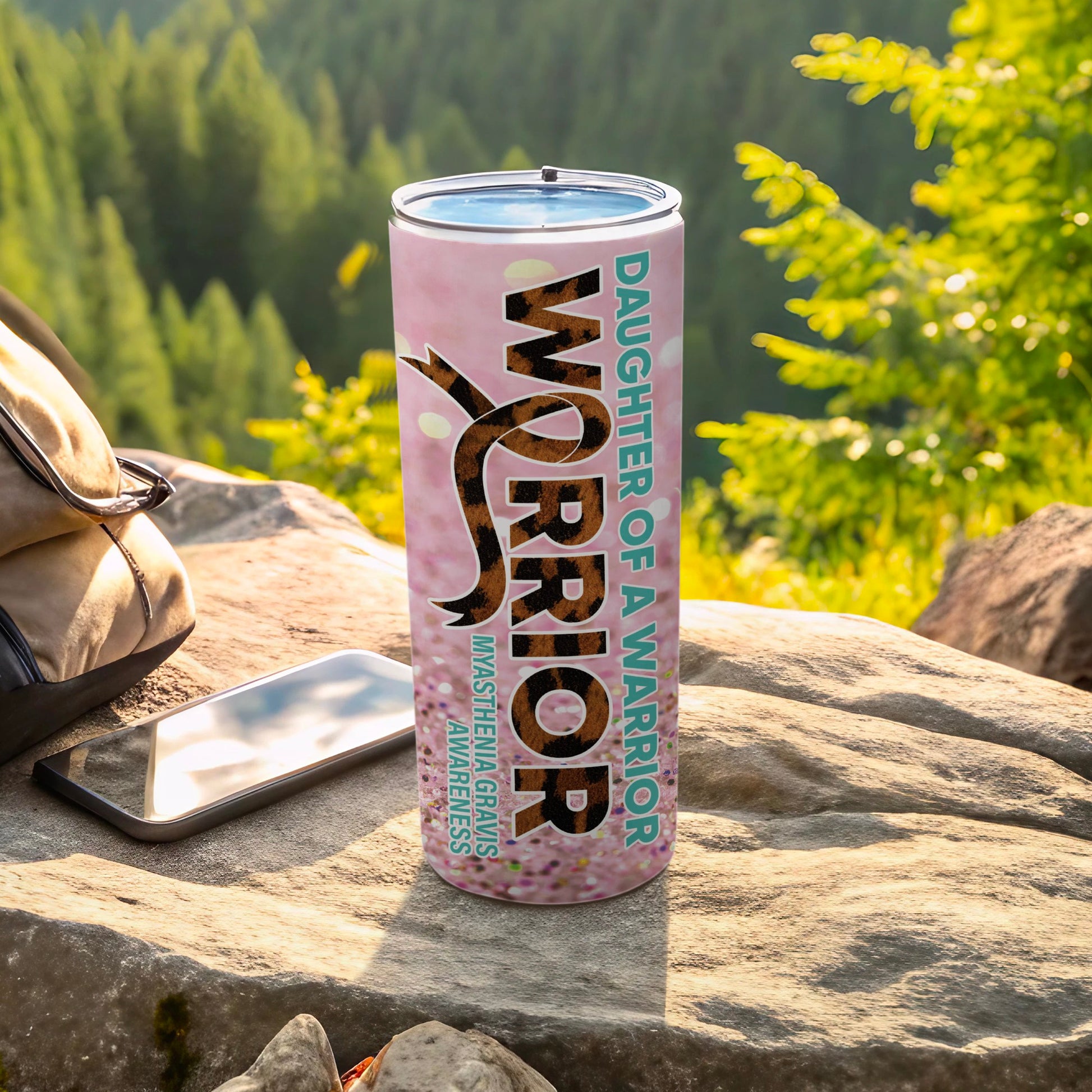 Pink tumbler with "Daughter of a Warrior" text and a ribbon.