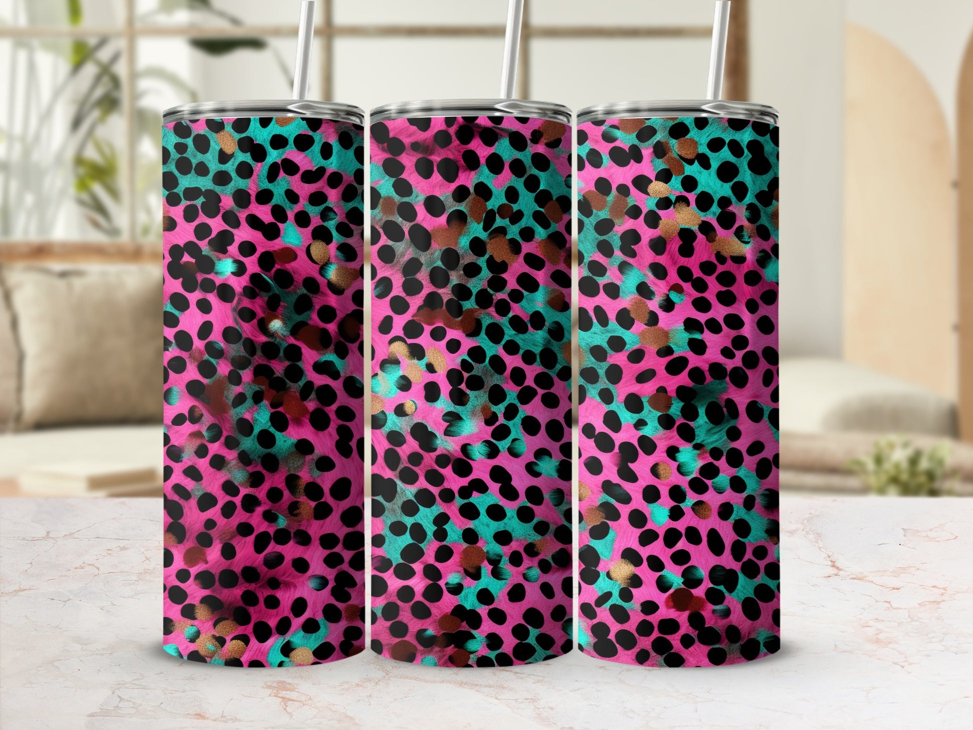 Tumbler with pink, teal, and gold leopard print pattern.