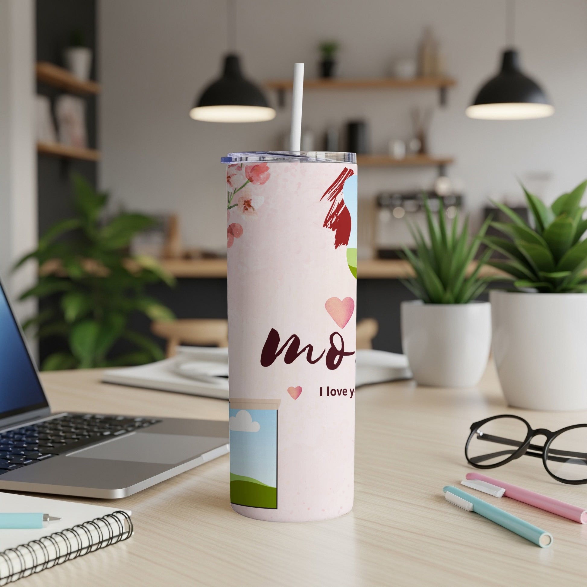 Light pink tumbler with floral and heart design, reading "mom I love y".