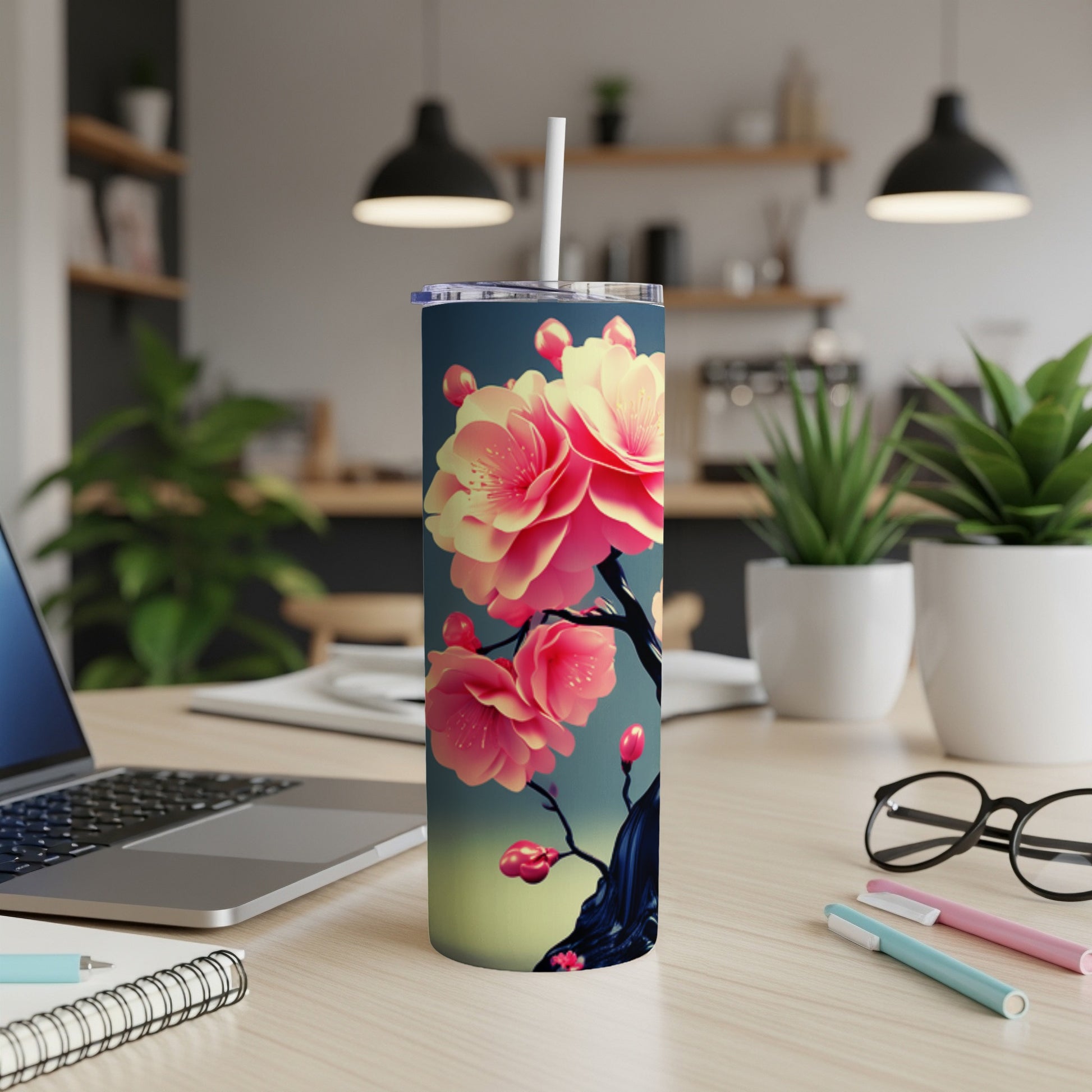 Floral tumbler with pink and yellow blossoms on a dark branch.