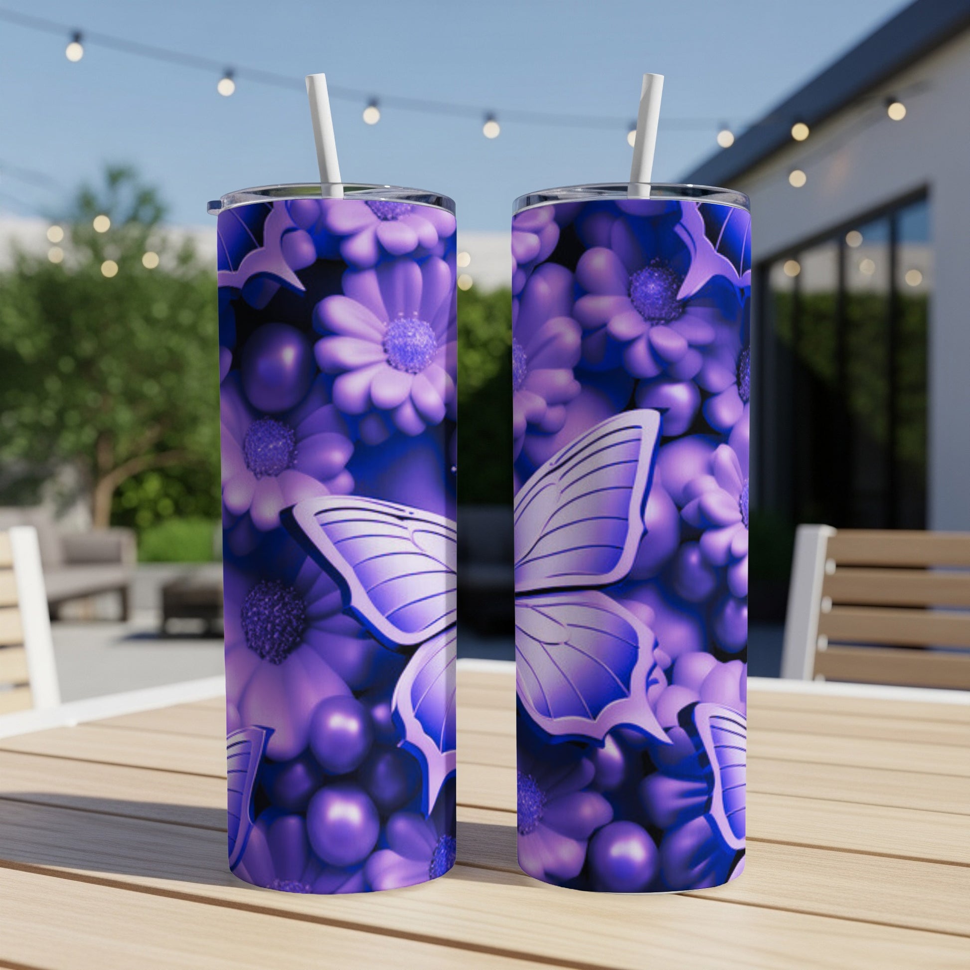 Two purple tumblers with butterfly and floral designs sit on a table.