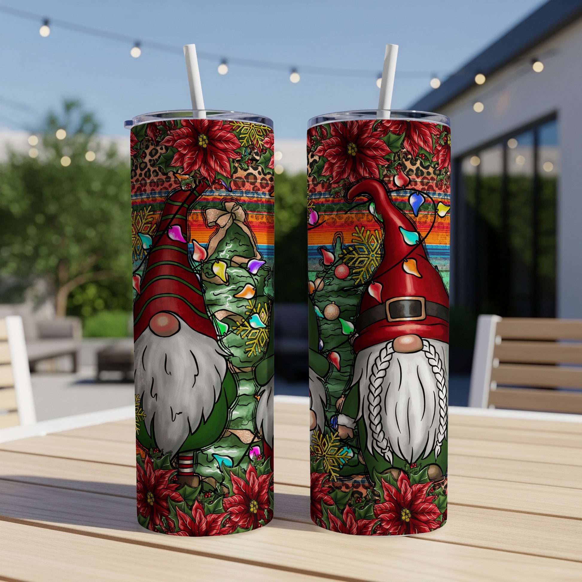 Two tumblers with Christmas gnomes, poinsettias, and festive lights.