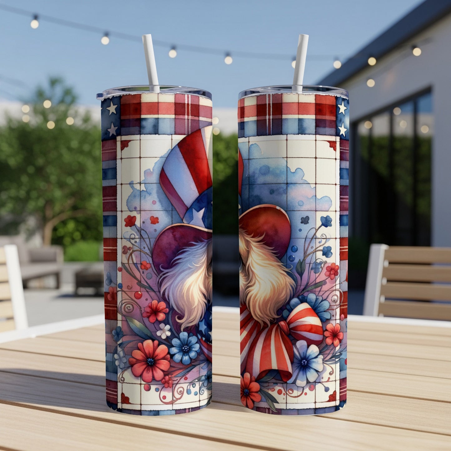 Patriotic gnome design on two tumblers with striped straws on a table.