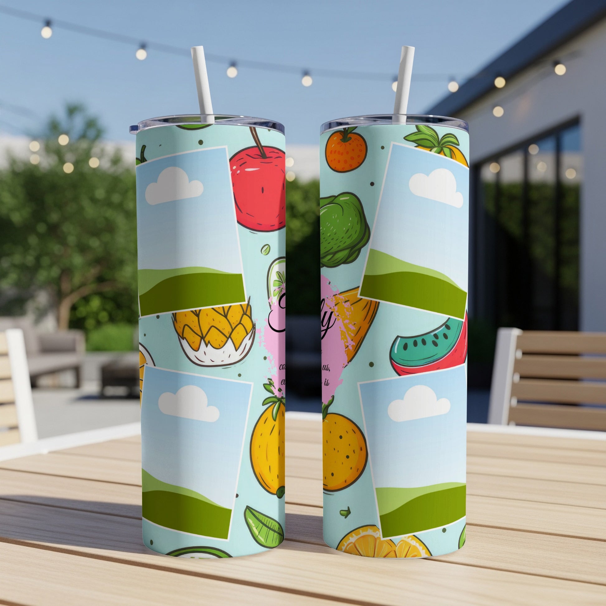 Two tumblers with a colorful fruit pattern and placeholder frames with sky and hills.