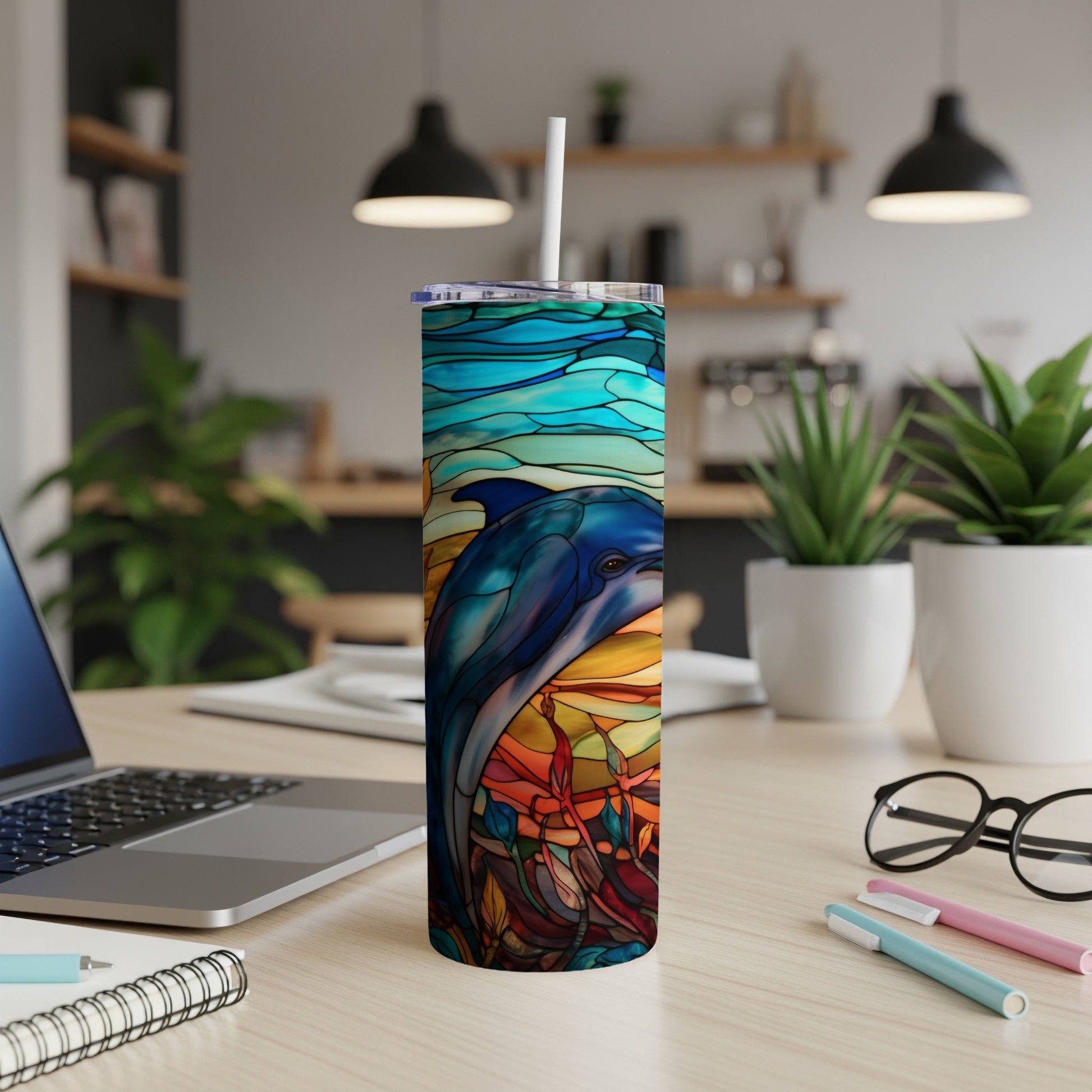 Colorful stained glass dolphin design on a white tumbler with straw.