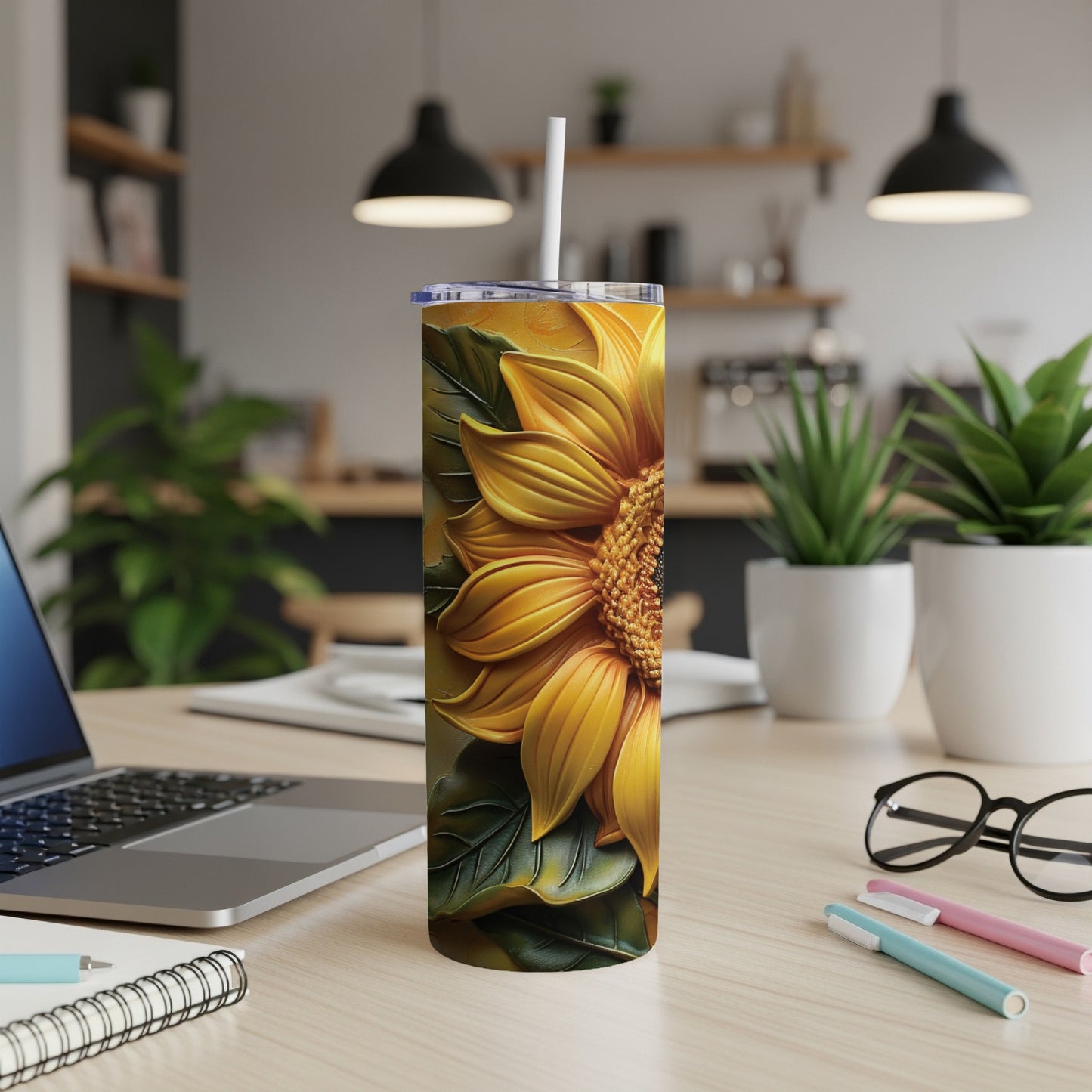 Yellow sunflower design on a tall, slim tumbler with a white straw.