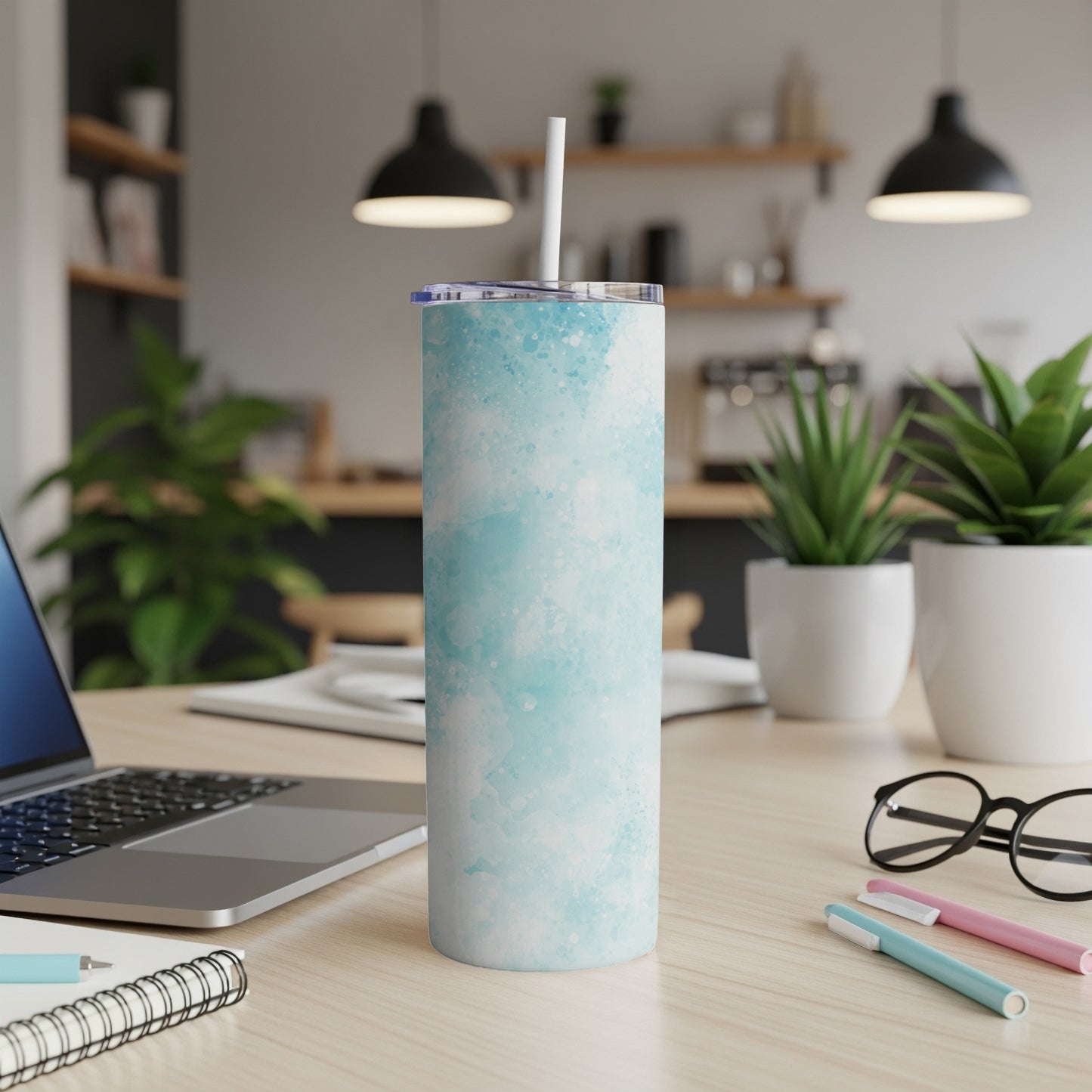 Blue watercolor pattern stainless steel tumbler with white straw.