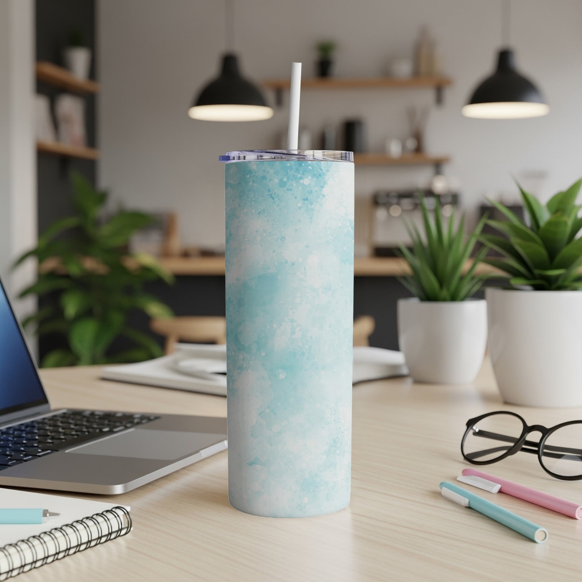 Blue watercolor pattern stainless steel tumbler with white straw.