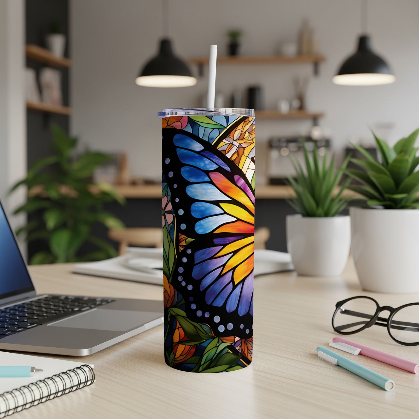Colorful butterfly stained glass pattern on a white skinny tumbler with a straw.