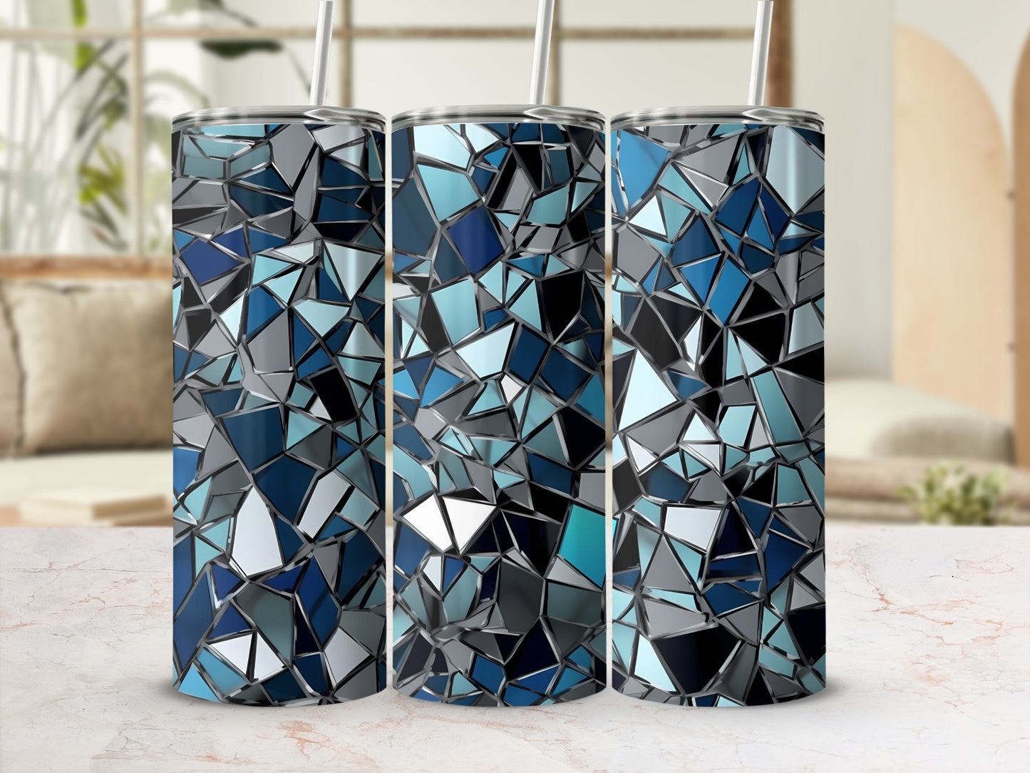 Three tall tumblers with a geometric mosaic pattern of blue and gray shapes.