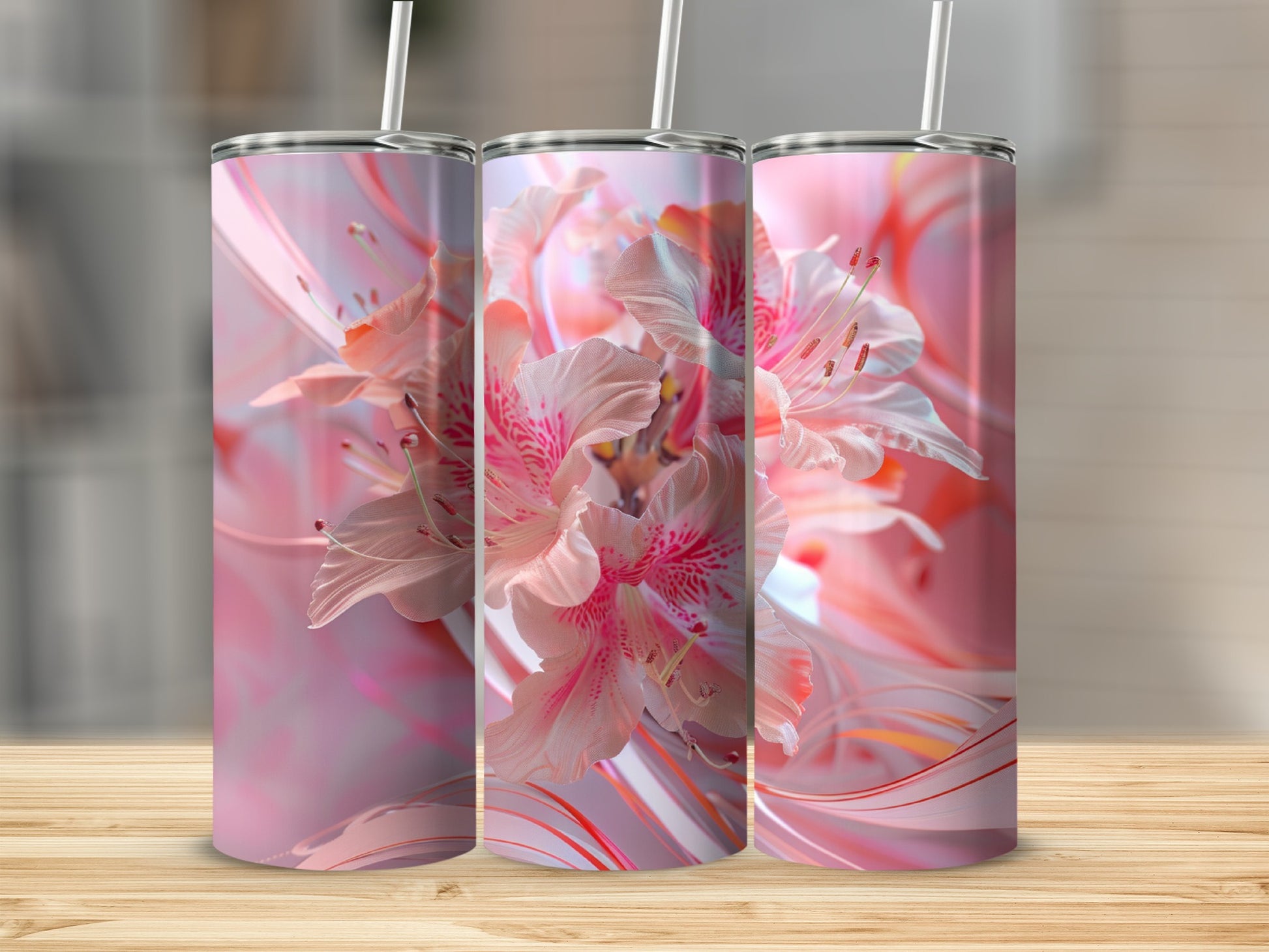 Three tall tumblers with pink floral designs on a wooden surface.