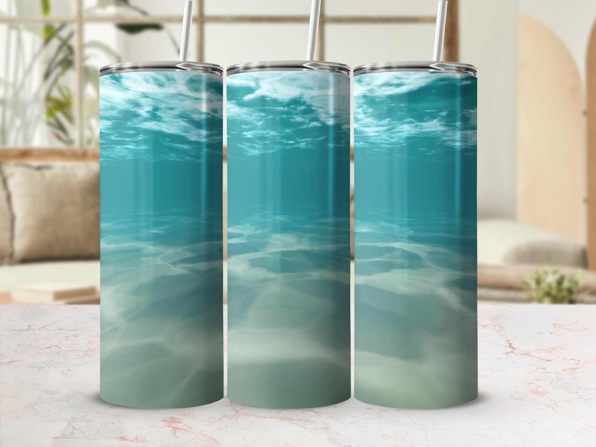 Three tumblers featuring an underwater ocean scene with light filtering through the water.