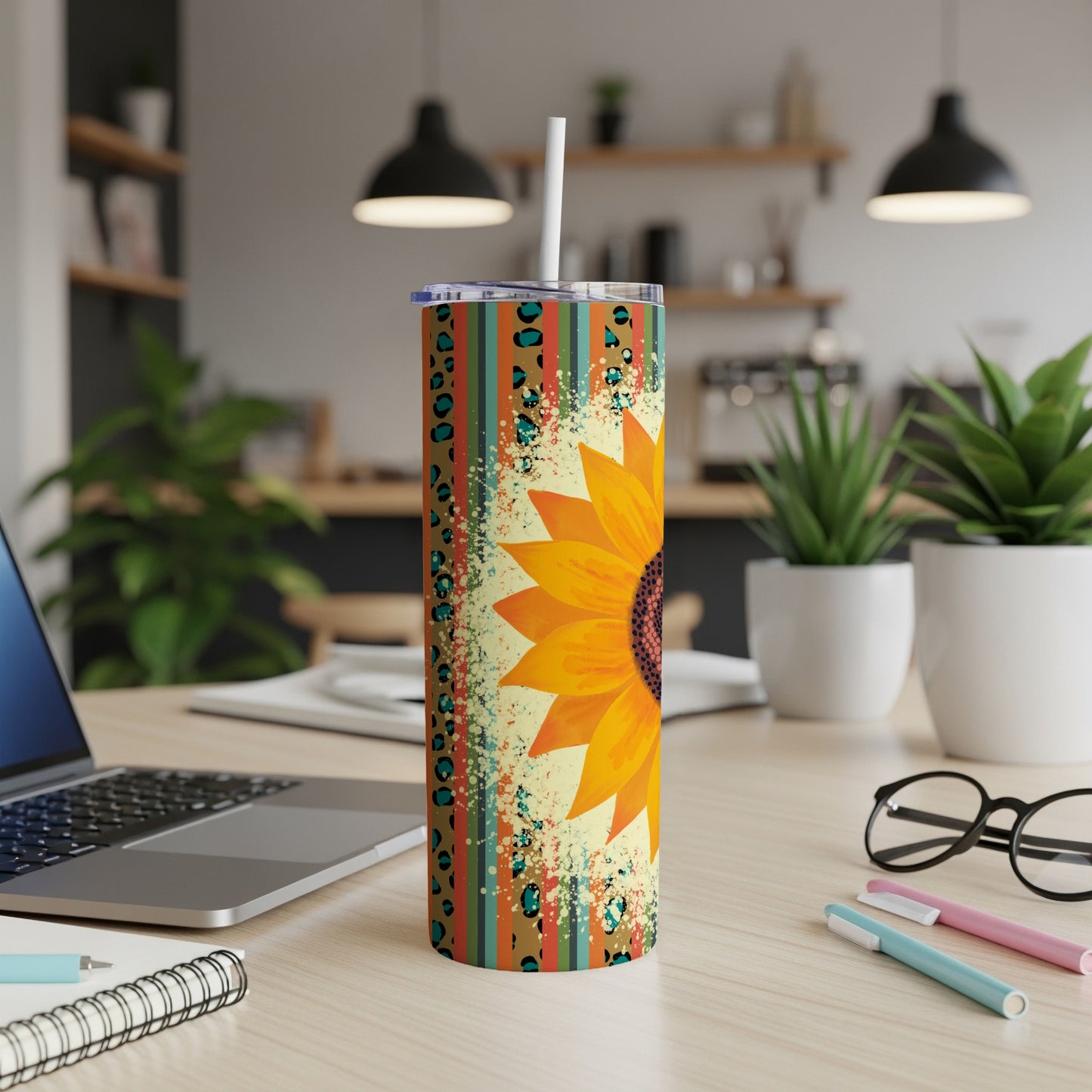 Sunflower tumbler with colorful striped and leopard print pattern.
