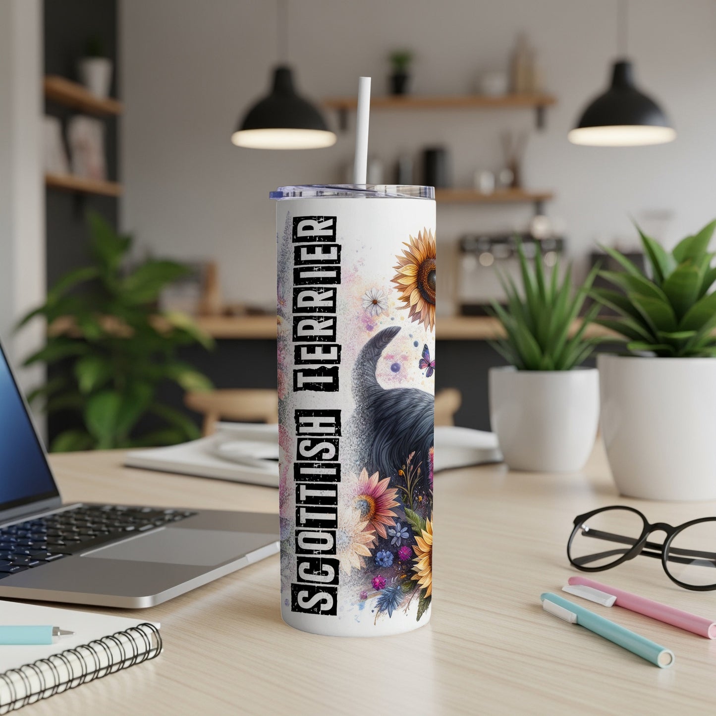 Tall tumbler with Scottish Terrier and floral design, straw inserted.