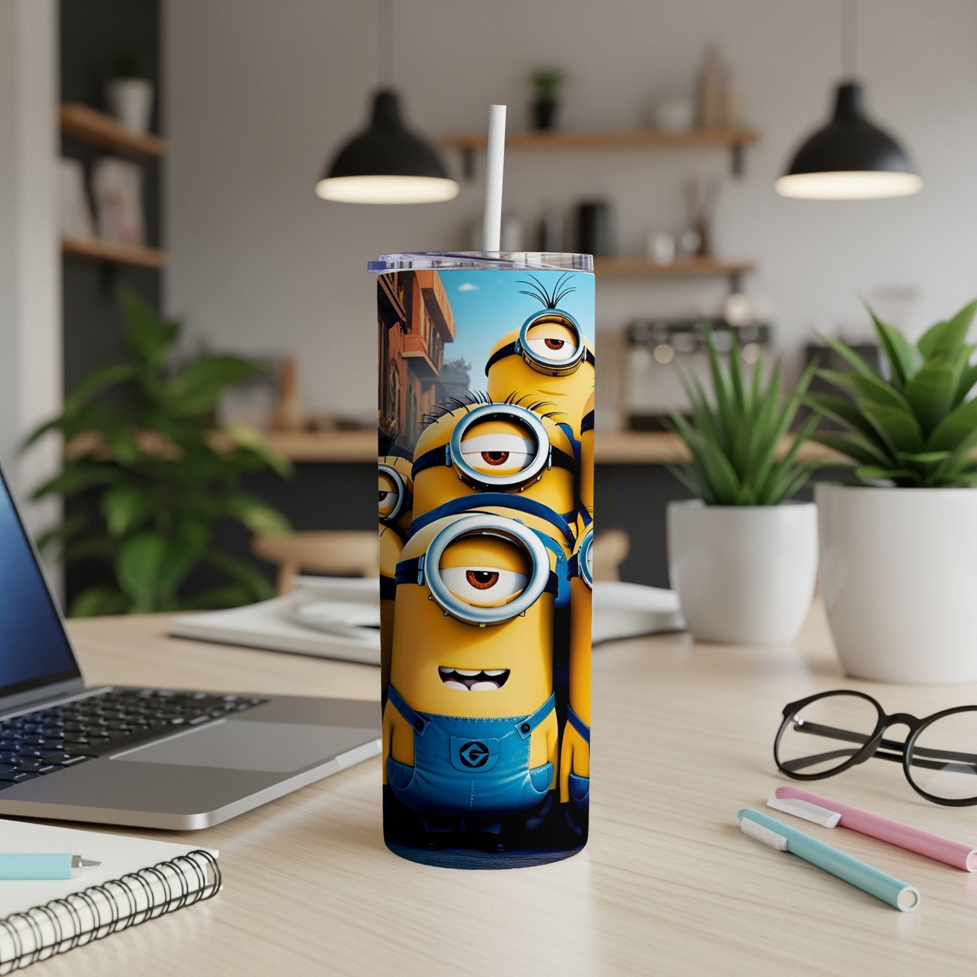 Three Minions in denim overalls stacked on a desktop tumbler.